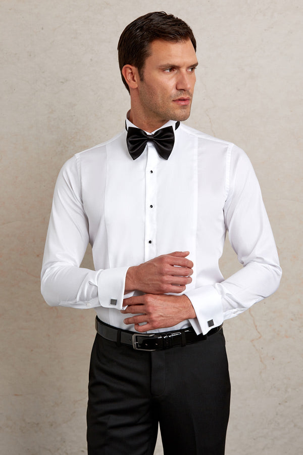 White tuxedo shirt with black bow tie and matching cufflinks.