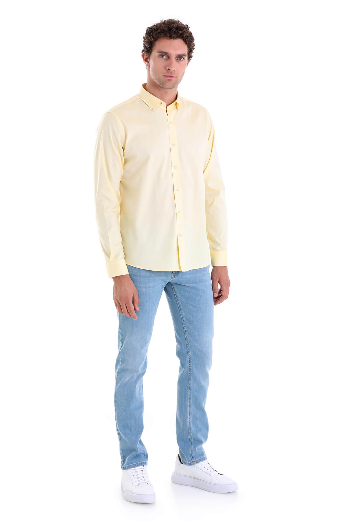 A pale yellow long-sleeved button-down shirt with a classic collar and neatly pressed fabric.