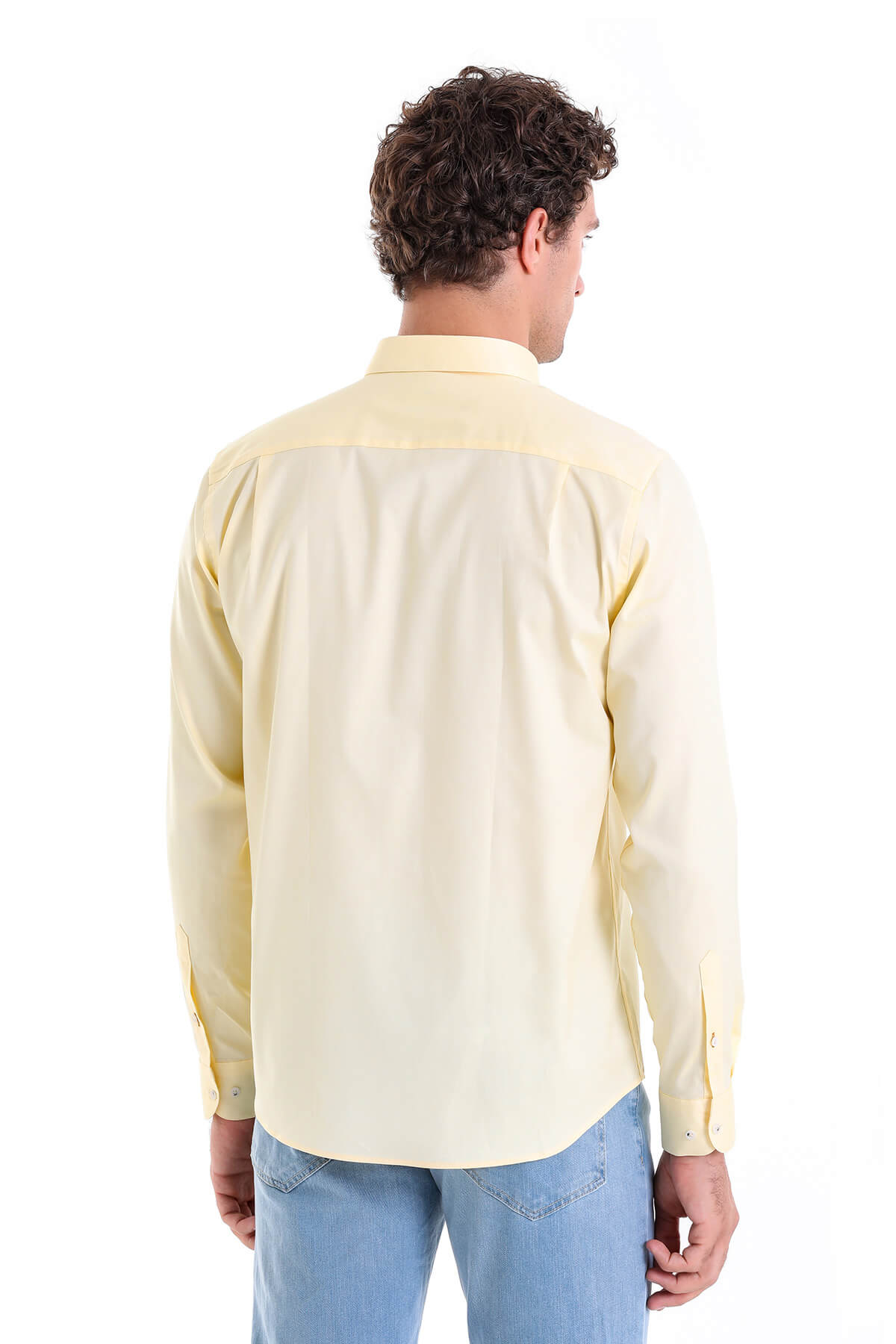A pale yellow, long-sleeved men’s dress shirt with a classic collar and buttoned cuffs.