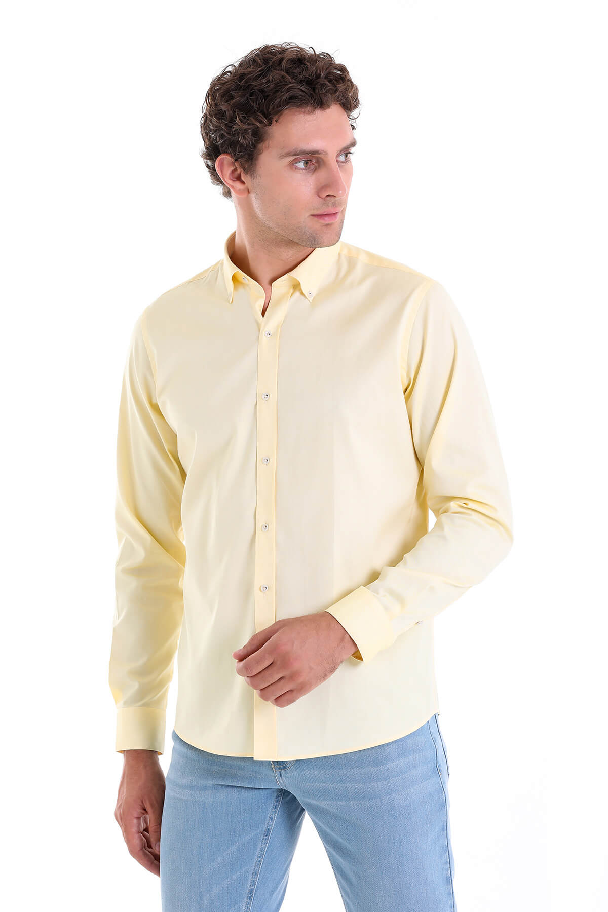 A pale yellow, long-sleeved men’s dress shirt with a classic button-down collar and neatly pressed fabric.