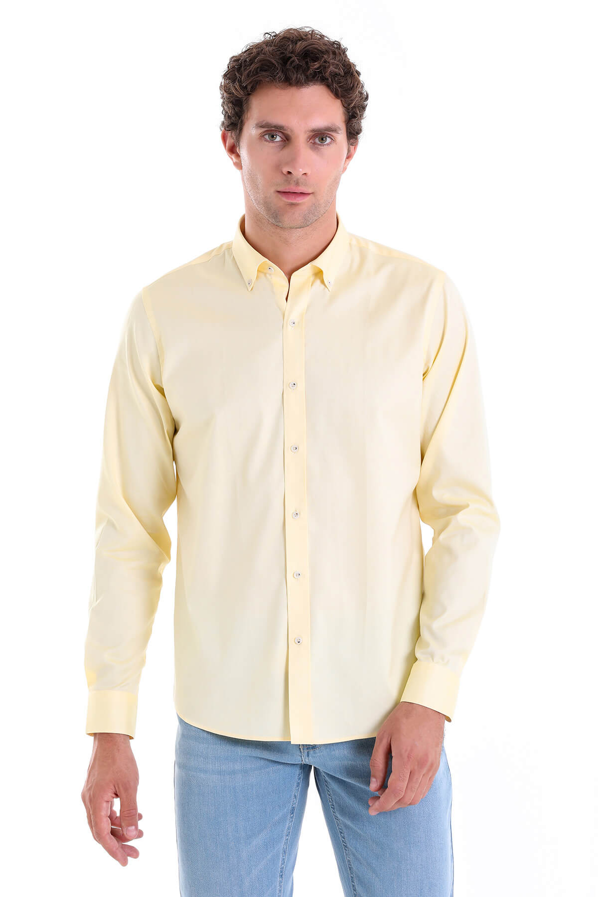 A pale yellow long-sleeved button-down shirt with a classic collar and neatly pressed fabric.