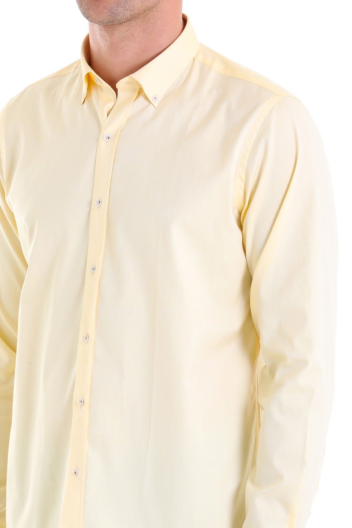 A pale yellow, long-sleeved men’s dress shirt with a classic collar and button-down front.