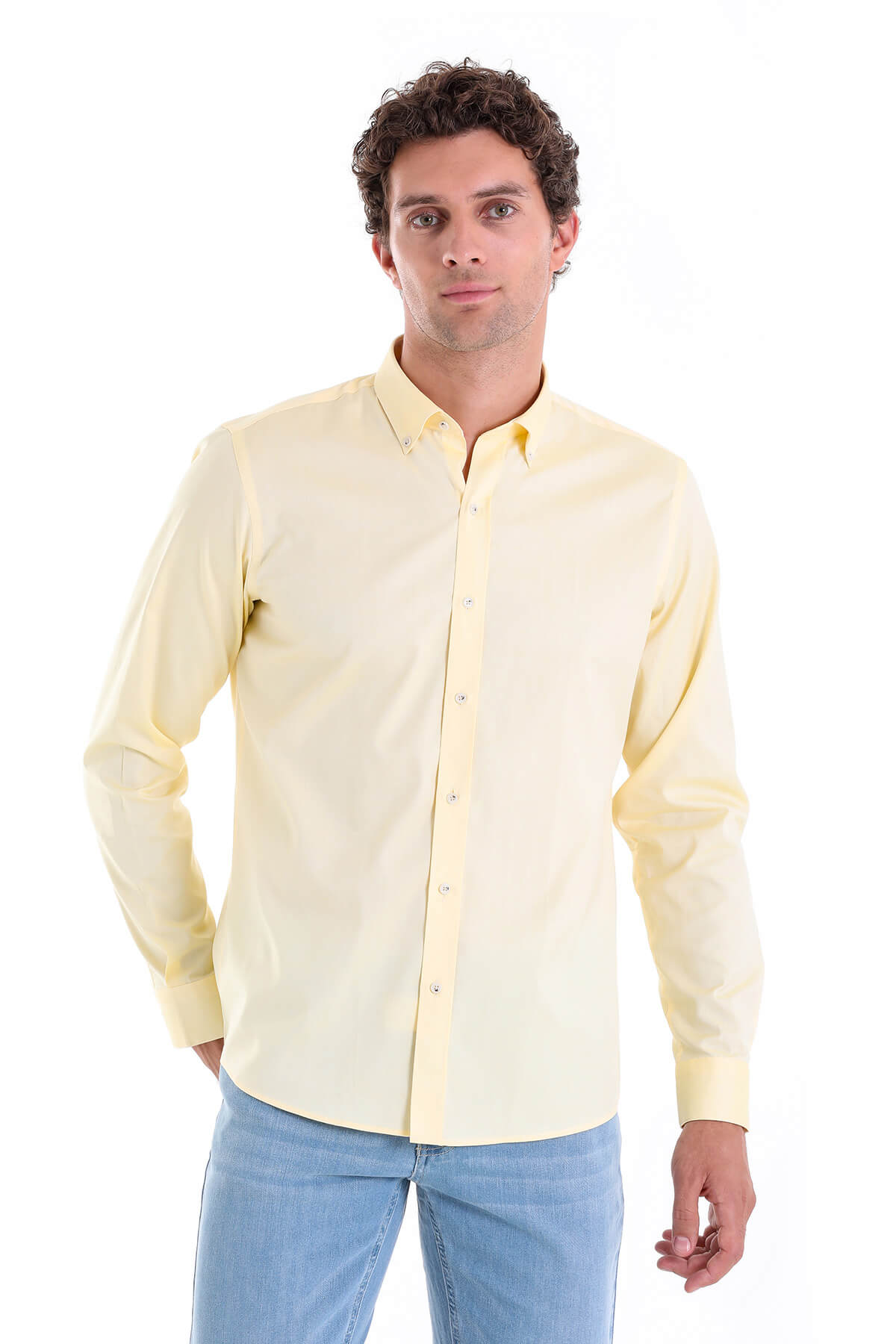 A pale yellow, long-sleeved button-down shirt with a classic collar and neatly pressed fabric.