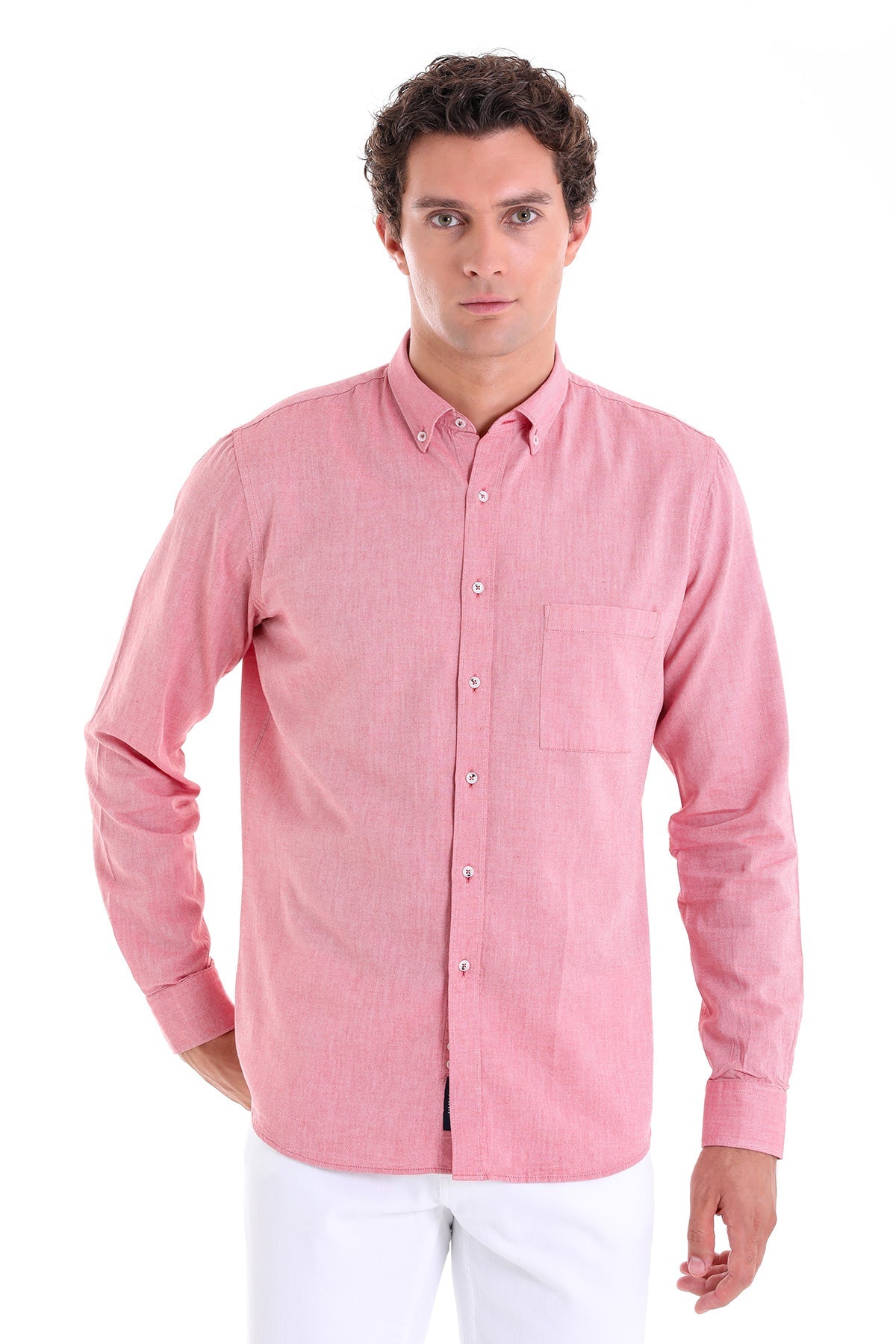 A men’s long-sleeved button-down shirt in a soft pink hue with subtle vertical stripes and silver-toned buttons.