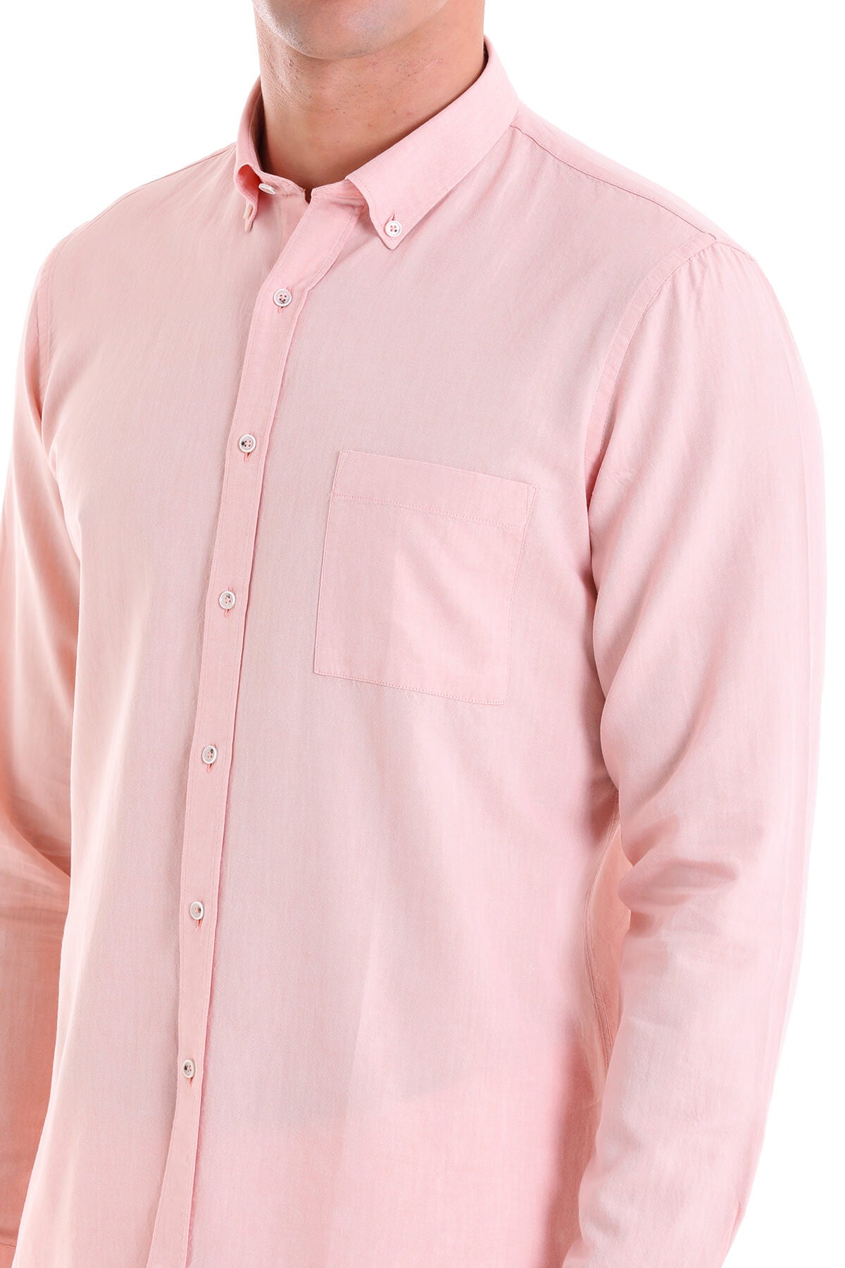 A soft pink long-sleeved button-down shirt with a classic collar and subtle chest pocket.