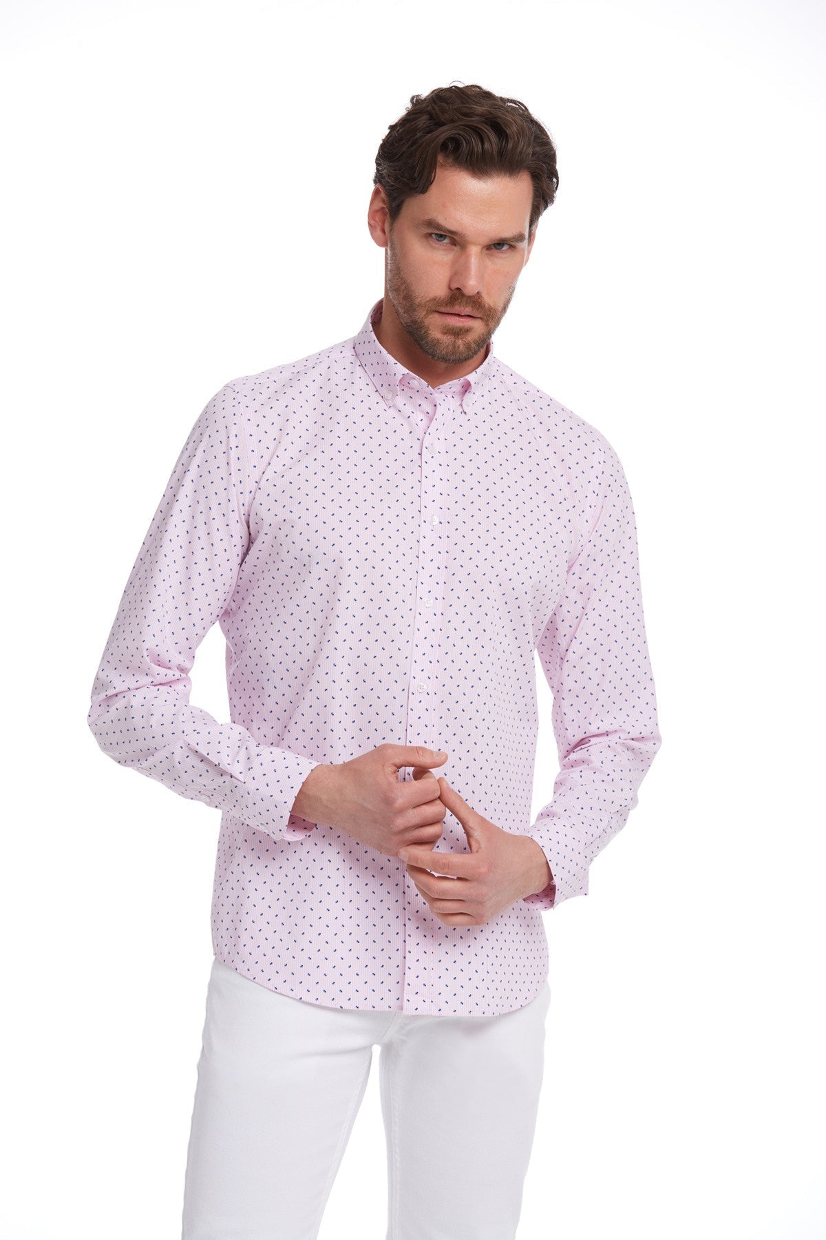 A light pink long-sleeved button-down shirt with a subtle pattern of small dark dots.
