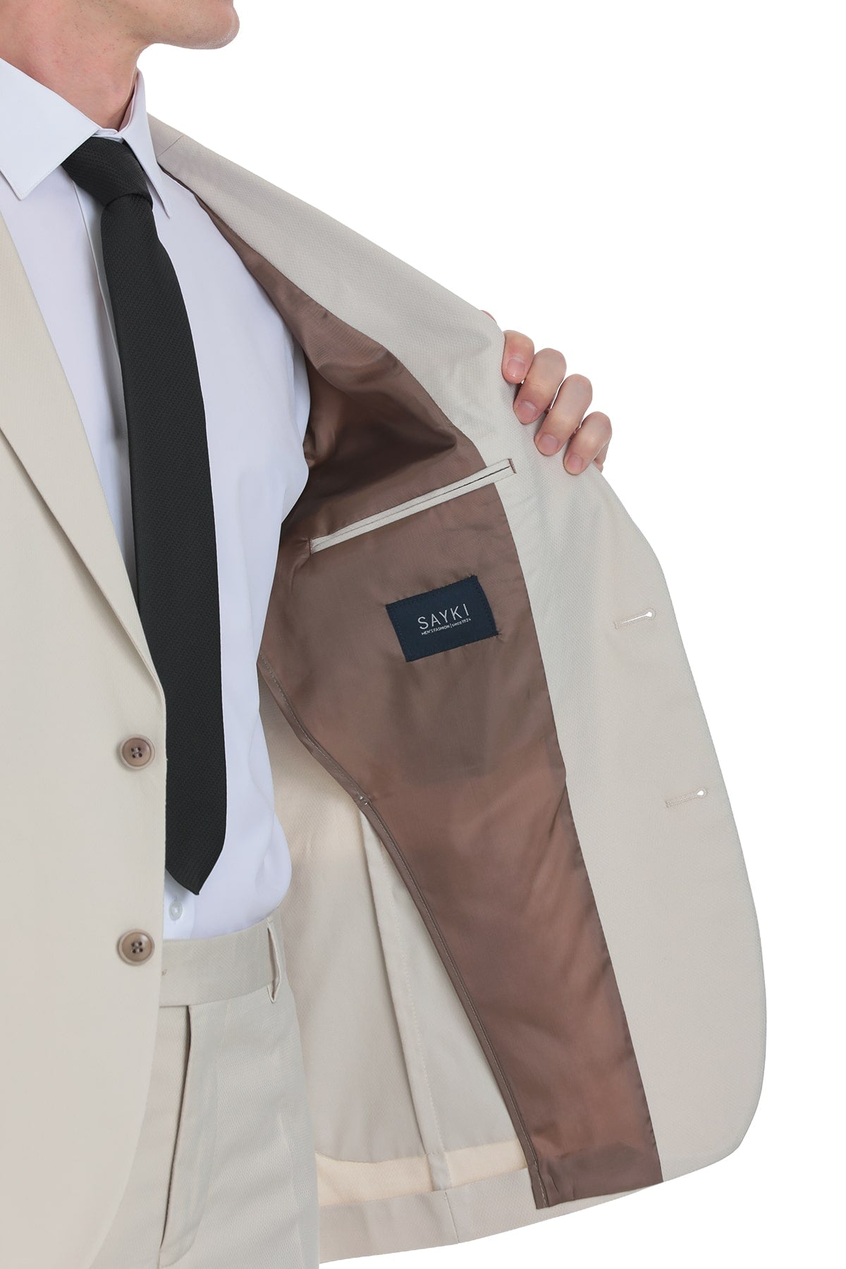 Beige men’s blazer with brown interior lining and a black ’sayki’ brand label.