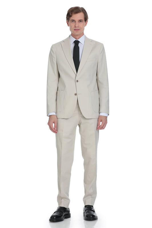 A man wearing a light beige two-piece suit with a black tie and white dress shirt.