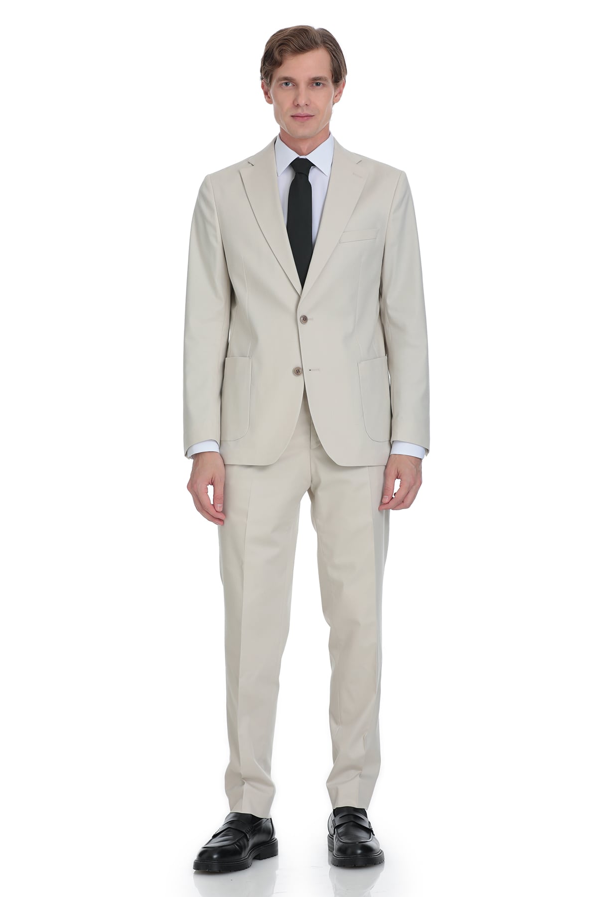 A man wearing a light beige two-piece suit with a black tie and white dress shirt.