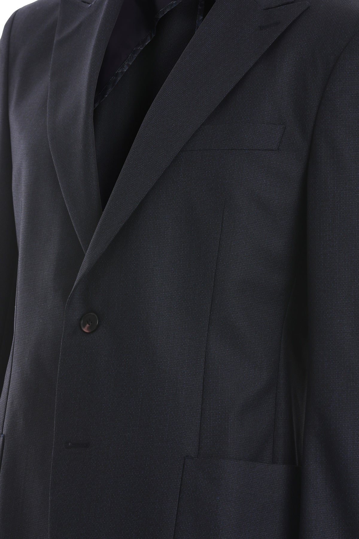 Black wool suit jacket with notched lapels and a single button closure.