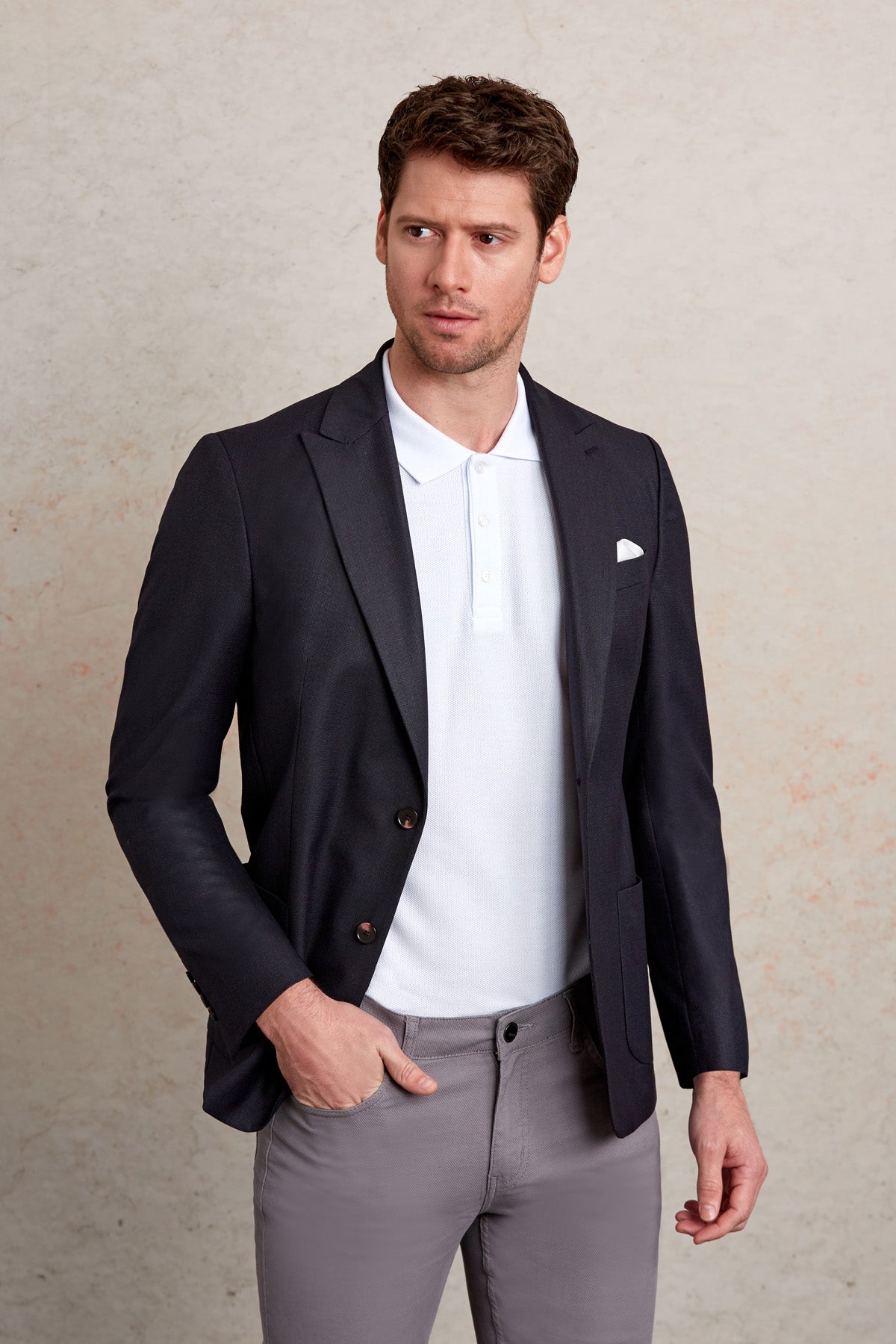 Black tailored blazer with notched lapels and two-button closure.