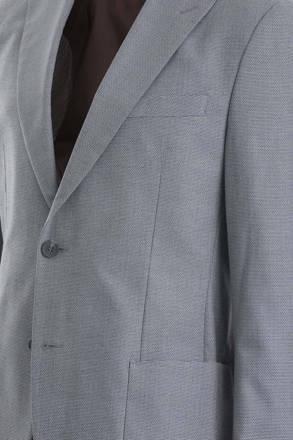 A tailored gray suit jacket with a subtle textured weave and matching dark buttons.