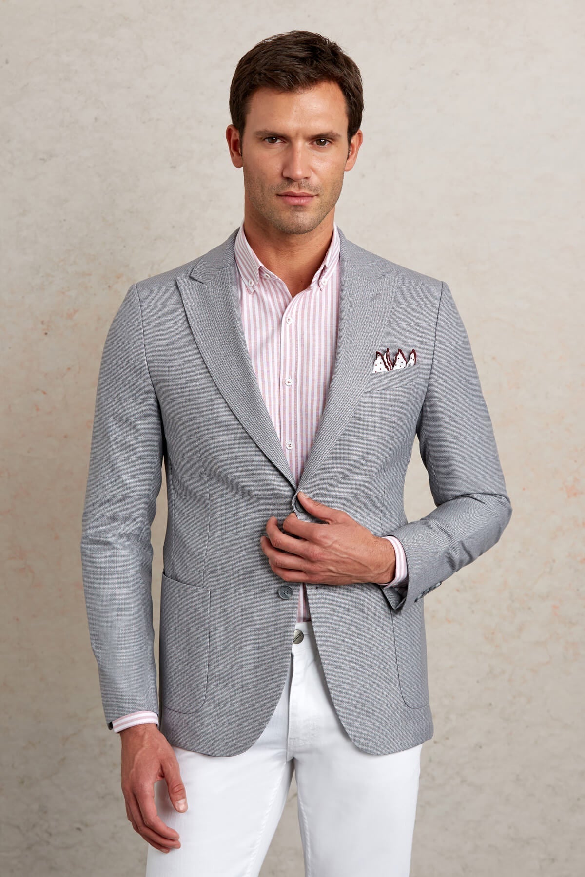 Light gray textured blazer with subtle pattern and a matching pocket square.