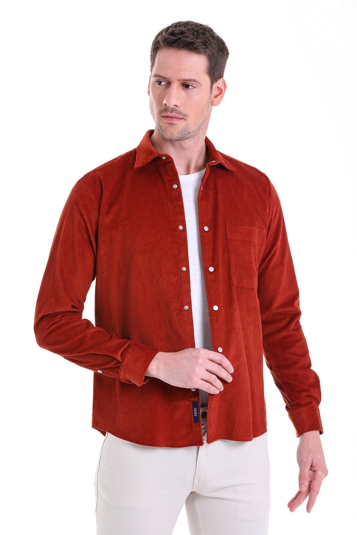 A rich rust-colored corduroy button-up shirt with a classic collar and long sleeves.