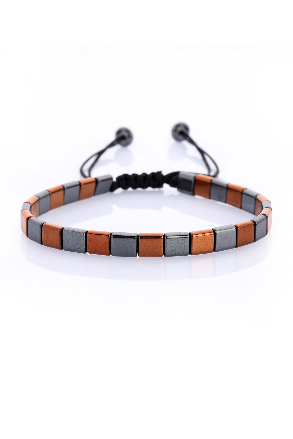 A sleek, adjustable bracelet featuring alternating copper and dark gray rectangular ceramic tiles strung on a black cord with matching spherical ends.