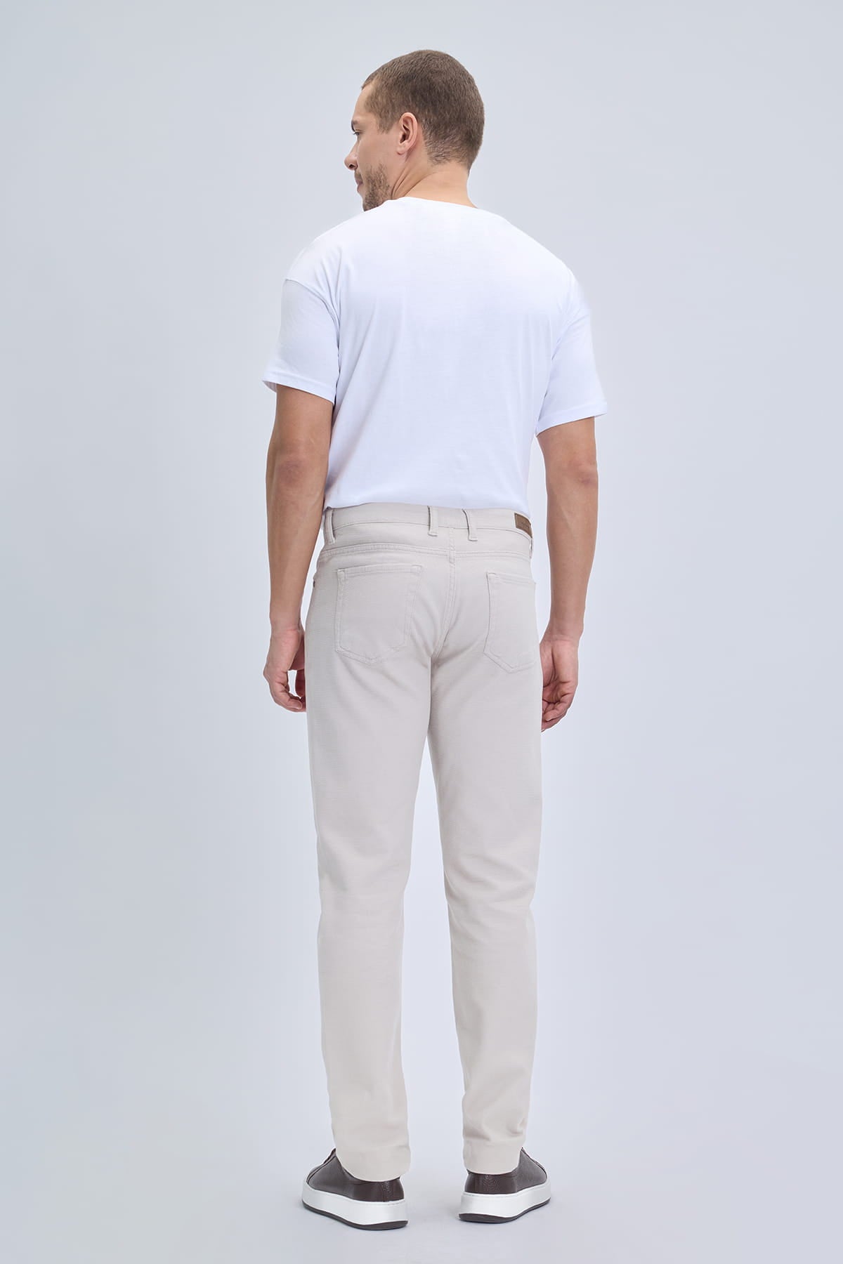 Beige slim-fit dynamic fit pocket low waist linen-tone casual pants with modern cut and subtle stitching details for smart casual wear