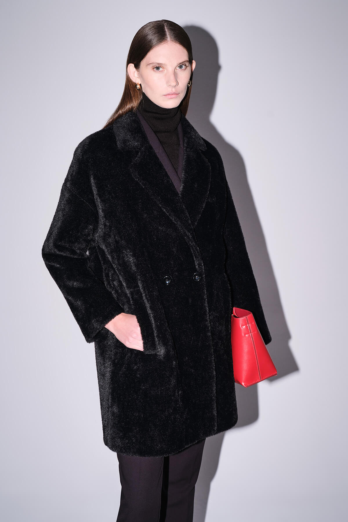 Black plush faux fur coat with a double-breasted design and soft, textured surface.