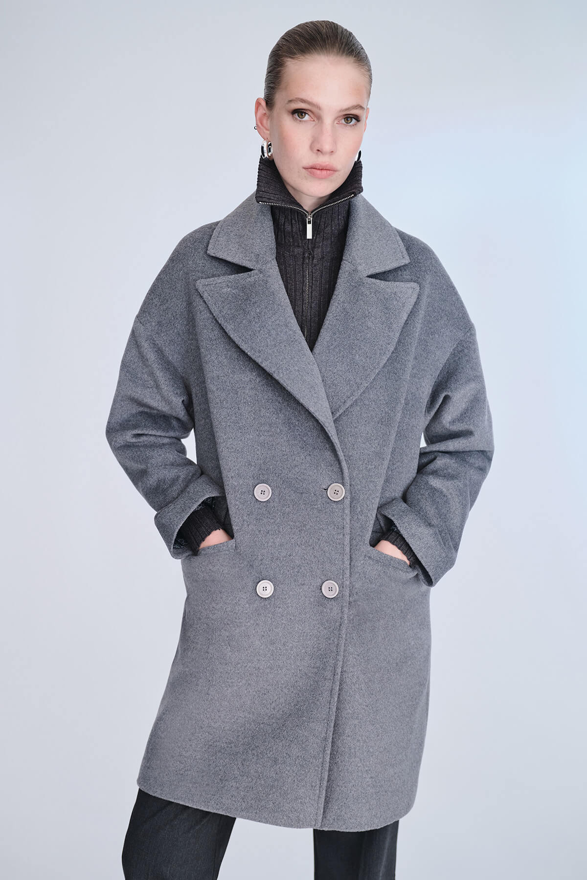 Gray wool double-breasted coat with silver buttons and a notched collar.