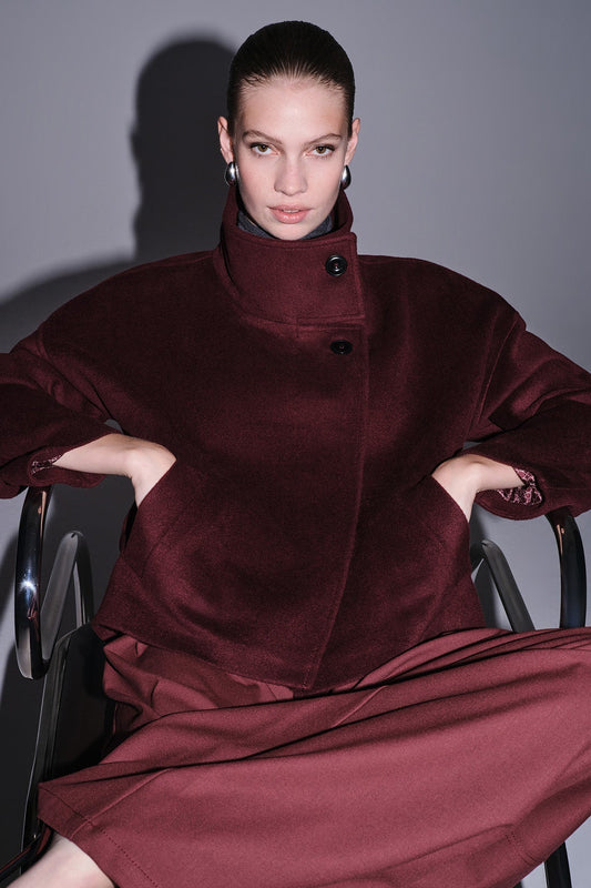 A rich burgundy velvet coat with a high collar and black buttons.