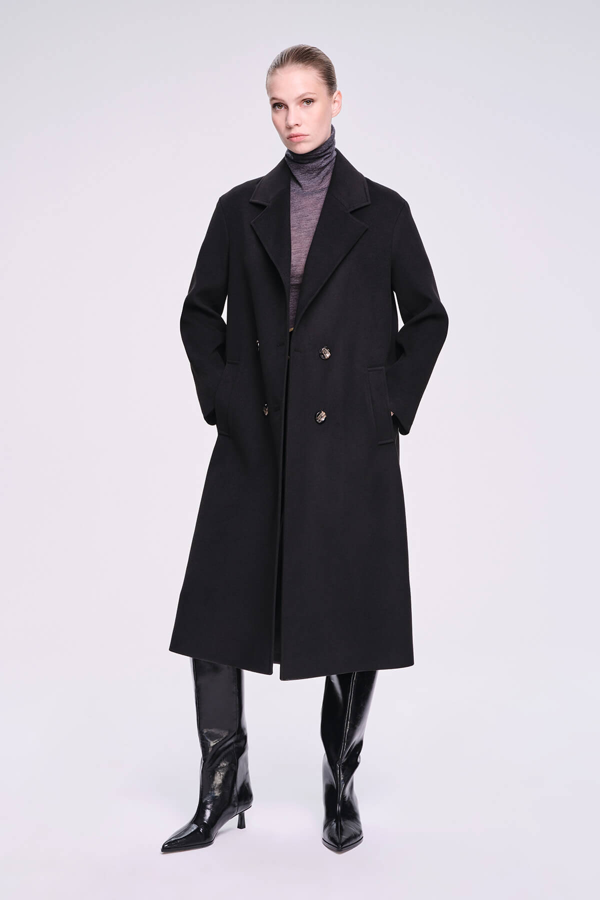 Black double-breasted trench coat with a structured collar and silver-toned buttons.