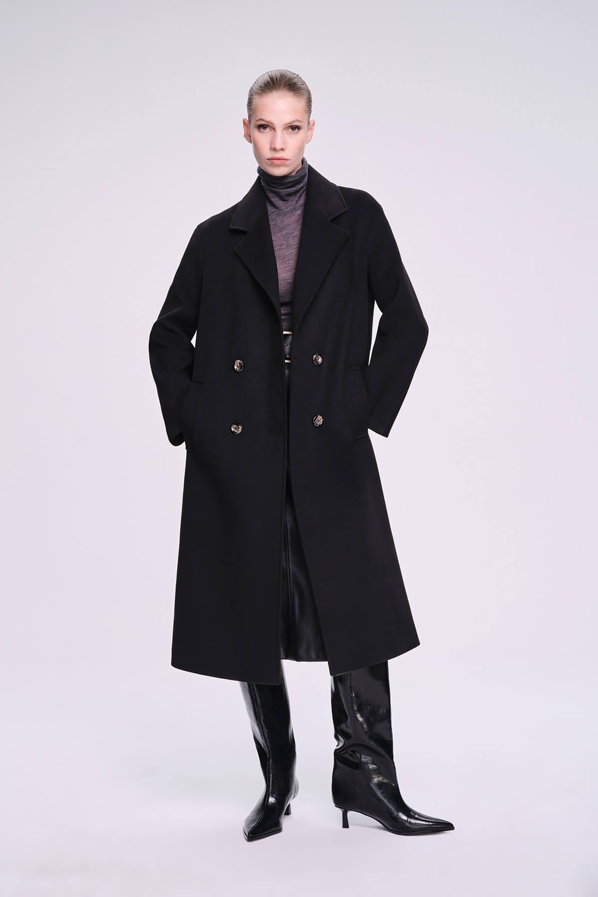 Black double-breasted wool coat with silver-toned buttons and a structured silhouette.