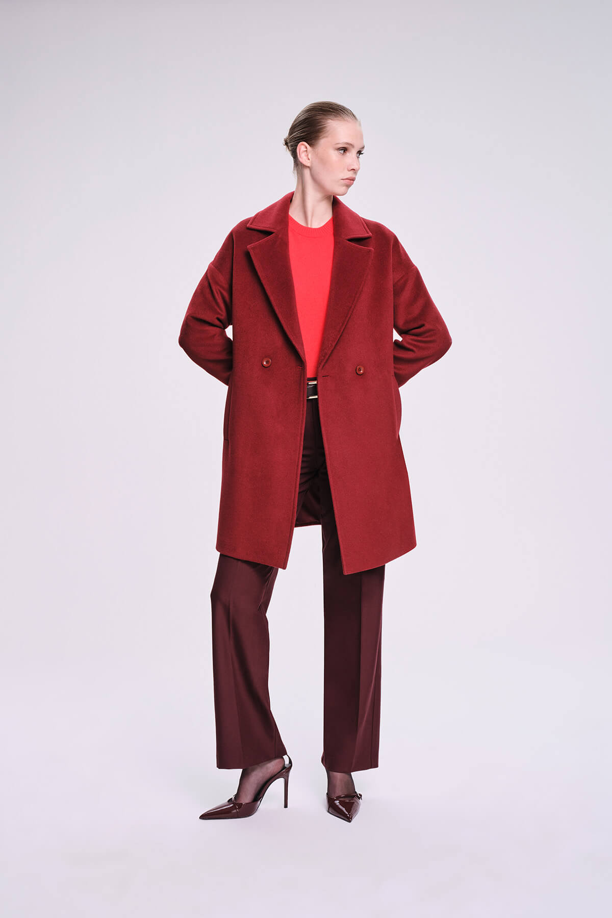 A rich burgundy double-breasted wool coat with a structured collar and matching buttons.