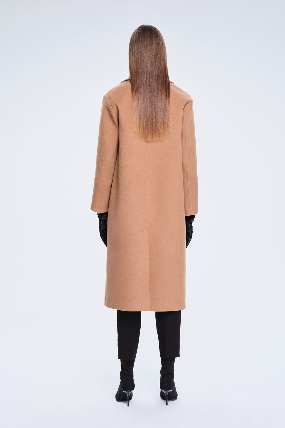 A camel-colored, longline wool coat with a classic double-breasted silhouette and notched lapels.