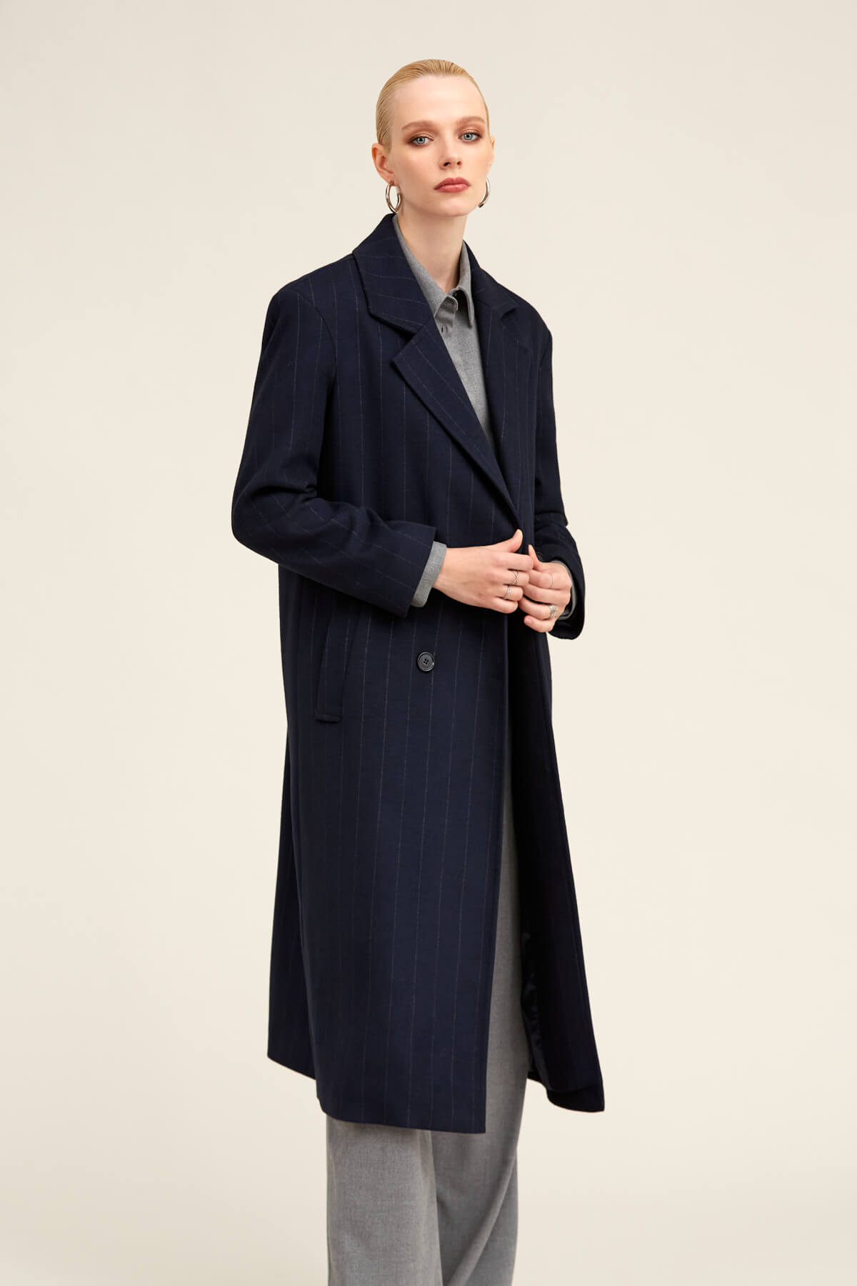 Navy blue pinstripe wool overcoat with notched lapels and double-breasted front