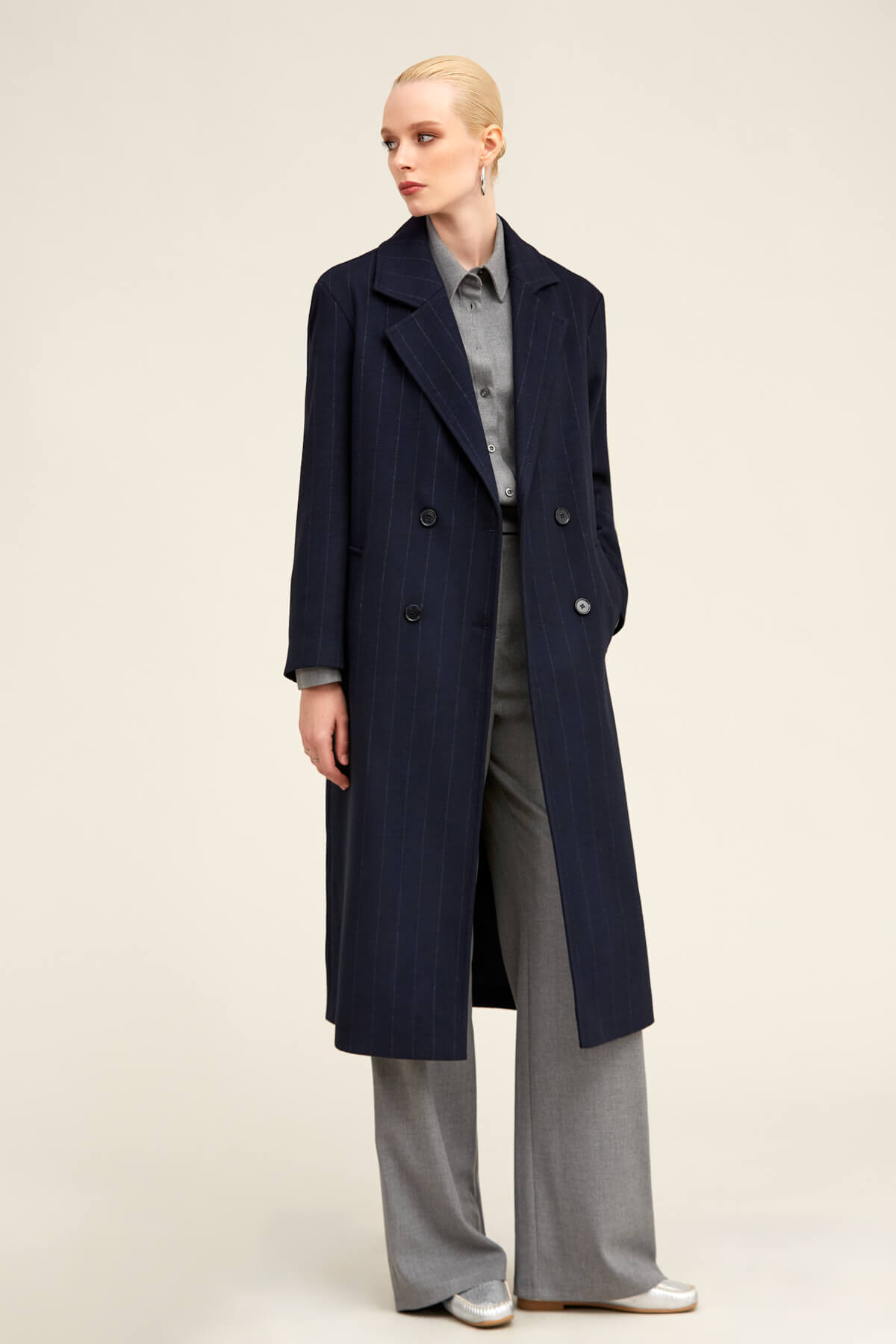 Navy blue double-breasted wool overcoat with notched lapels and dark buttons