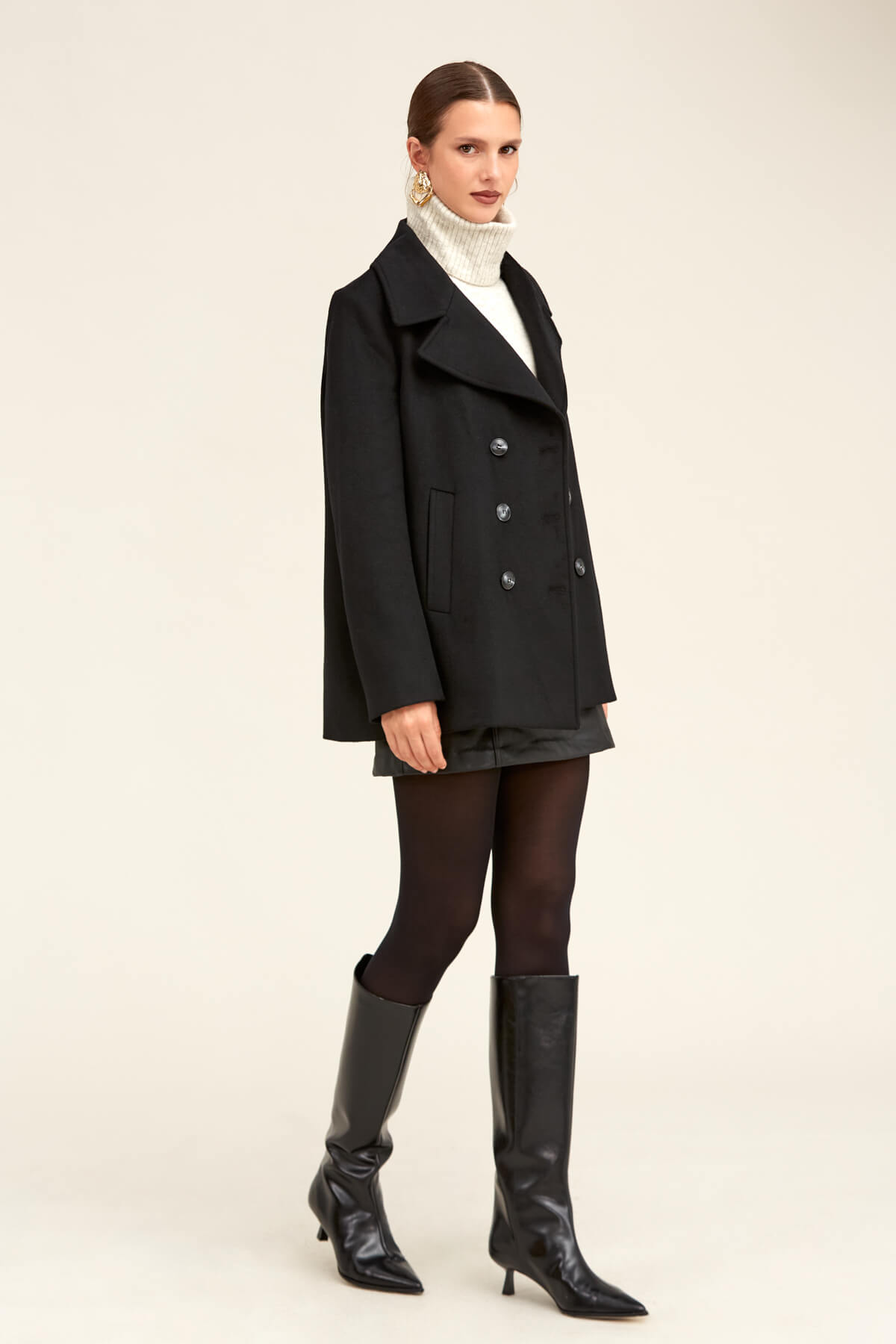 Black double-breasted wool coat with notched lapels and silver buttons.