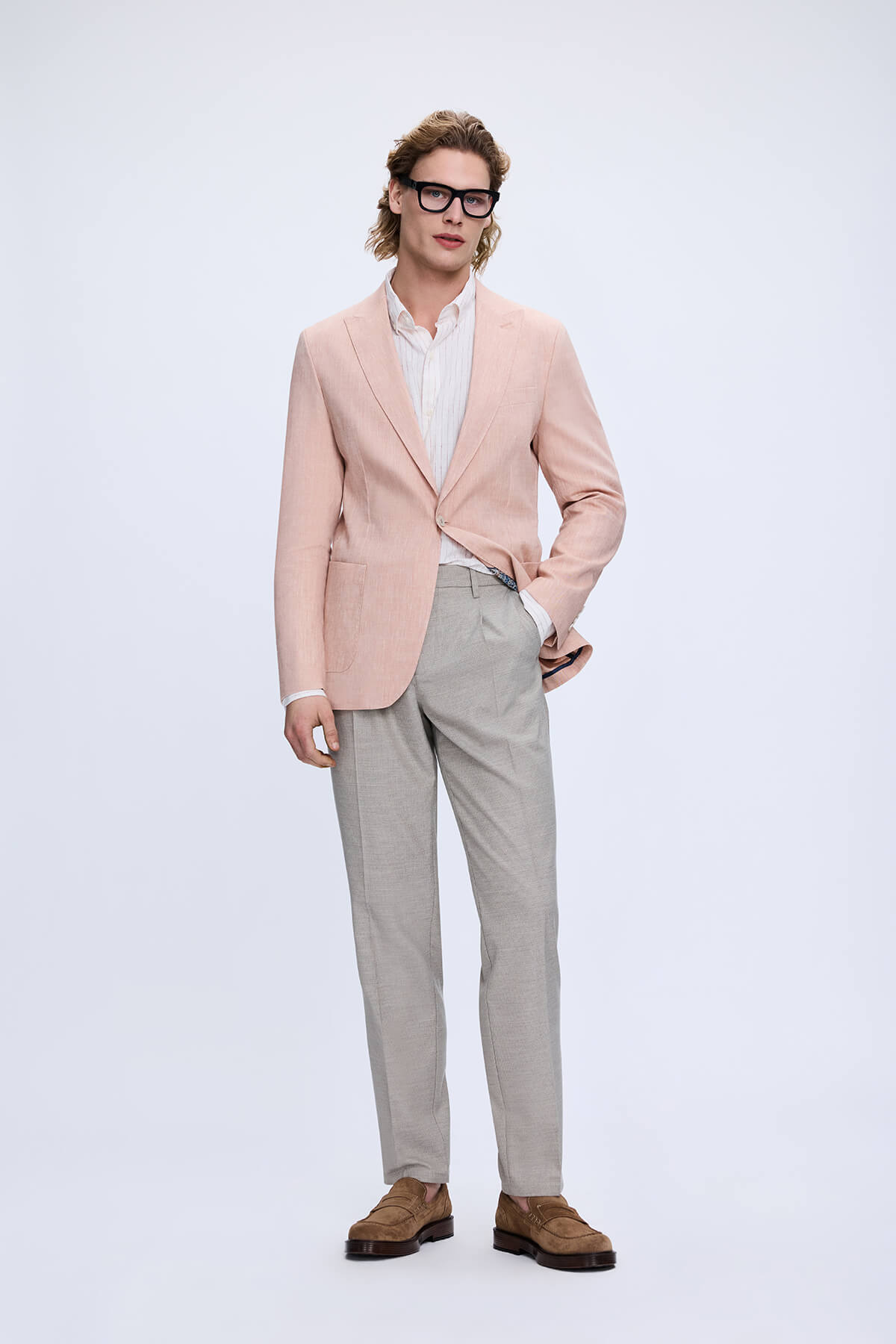 A light pink tailored blazer with subtle texture worn over a white shirt paired with dynamic fit gray linen blend jogger pants