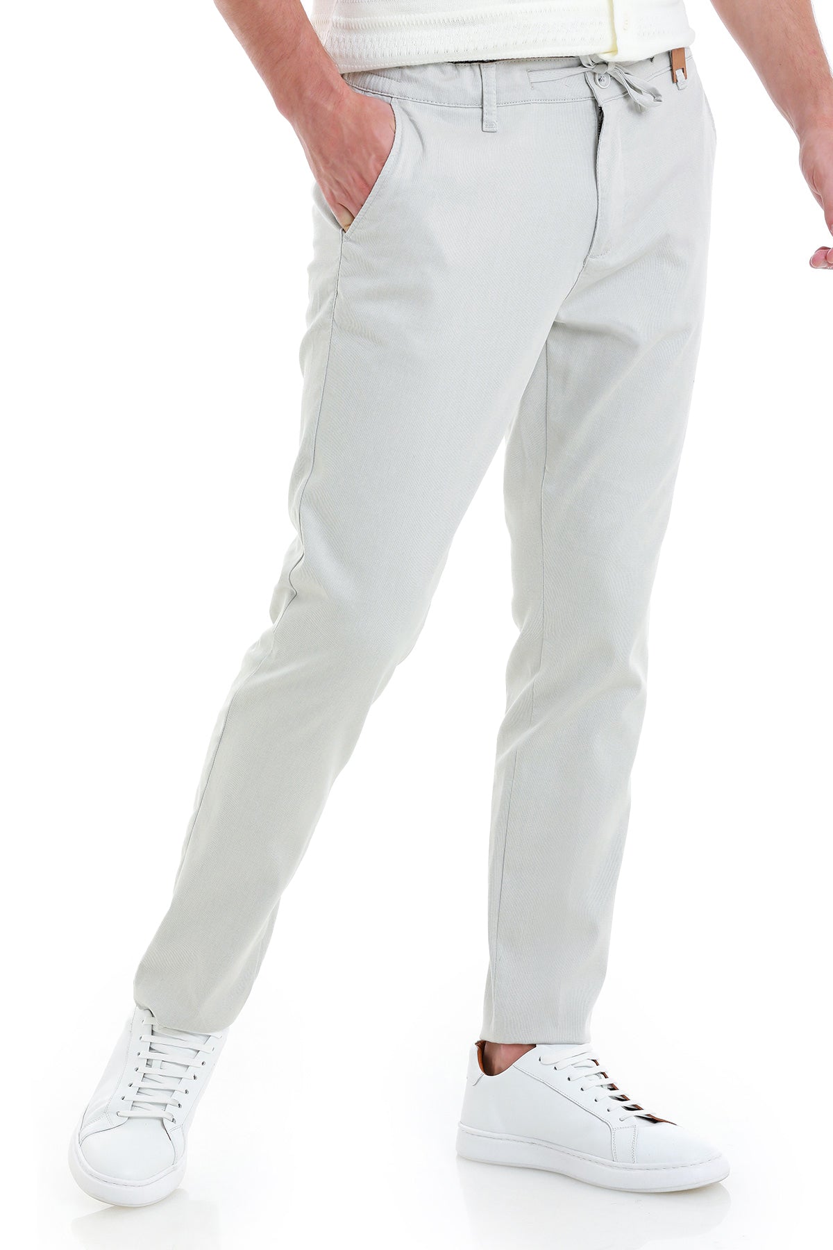 Light gray chino pants with a drawstring waistband and tapered legs.