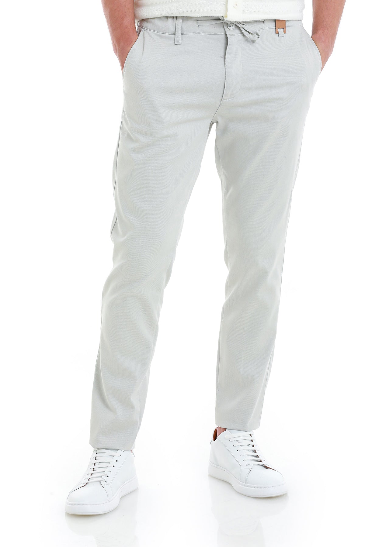 Light gray chino pants with a drawstring waistband and subtle side pockets.