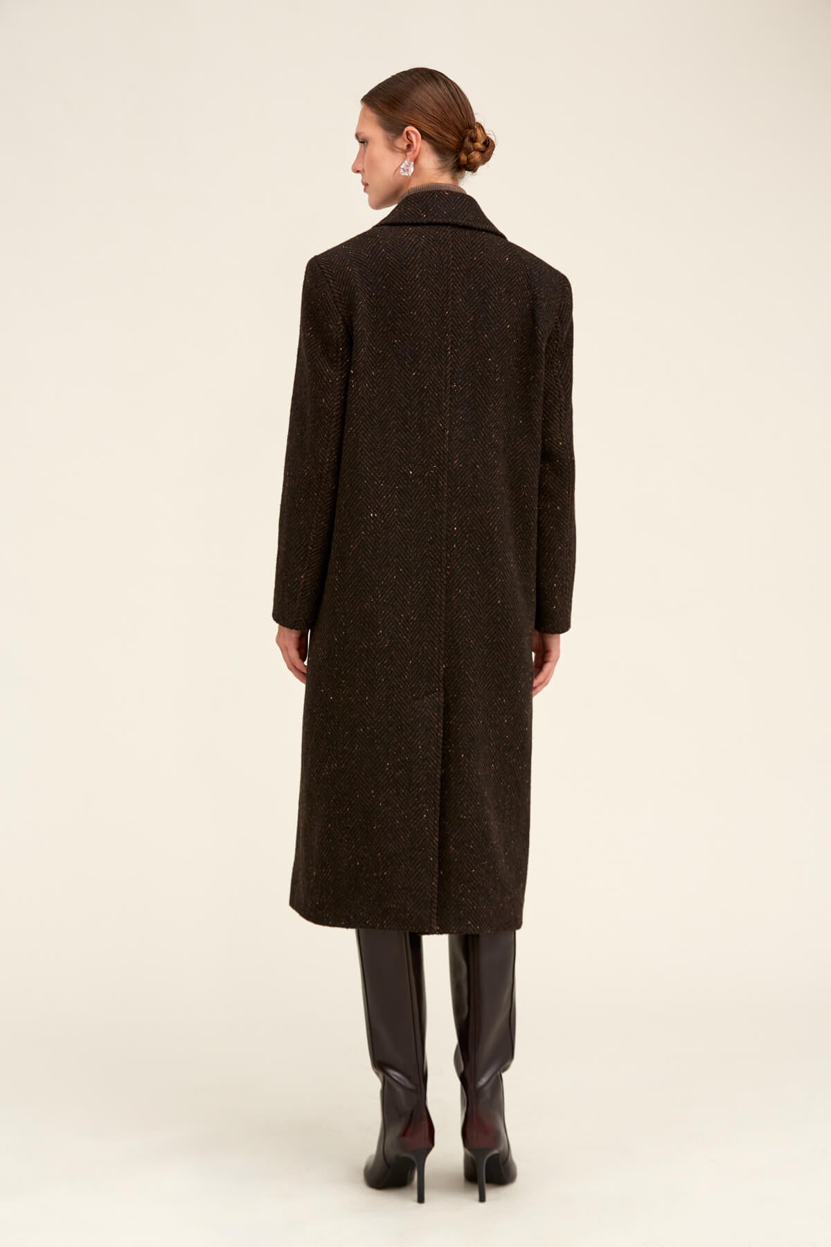 A dark brown, long wool coat with a subtle speckled texture and classic collar.