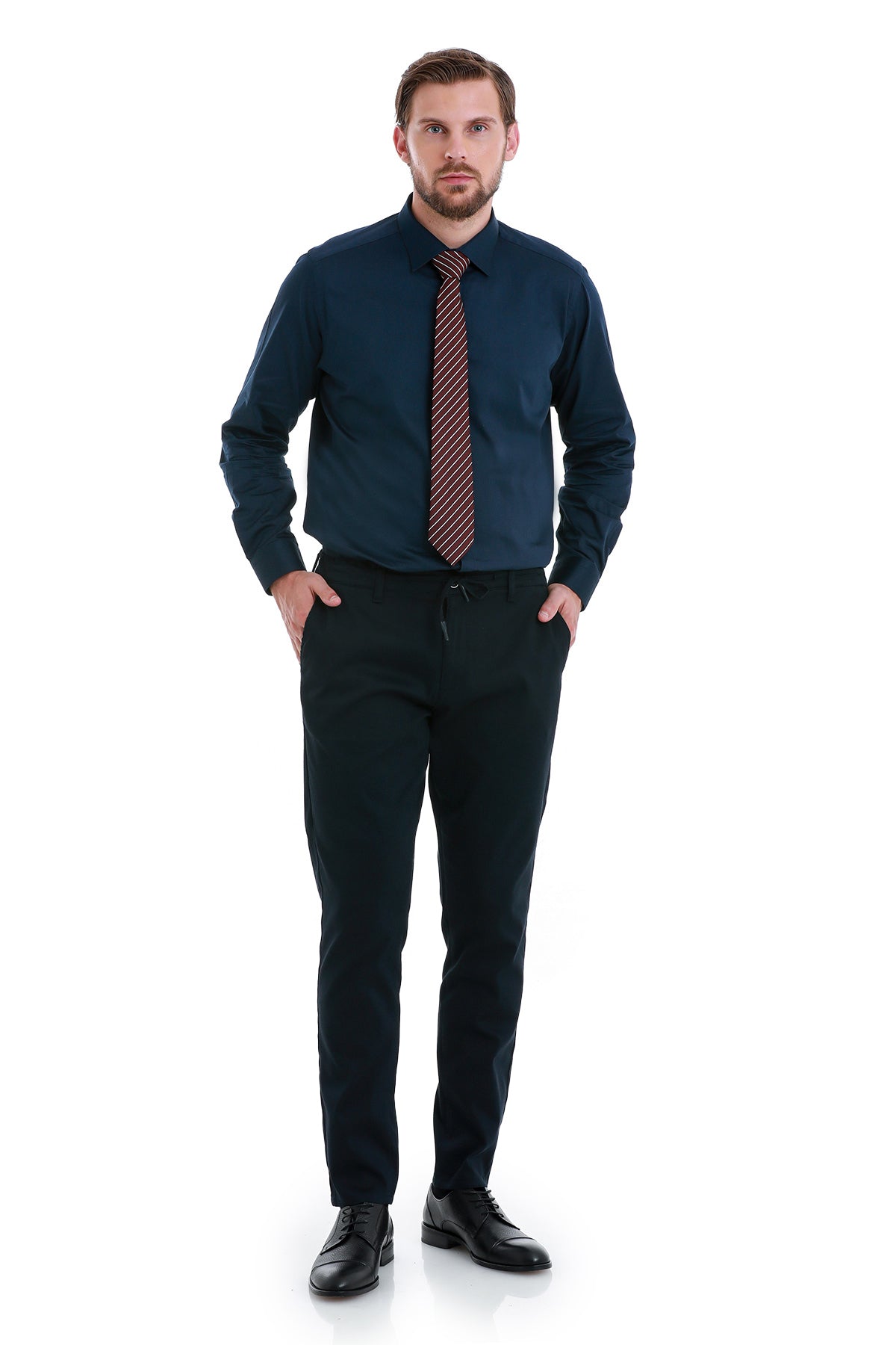 A man wearing a navy blue dress shirt with a red and black striped tie.