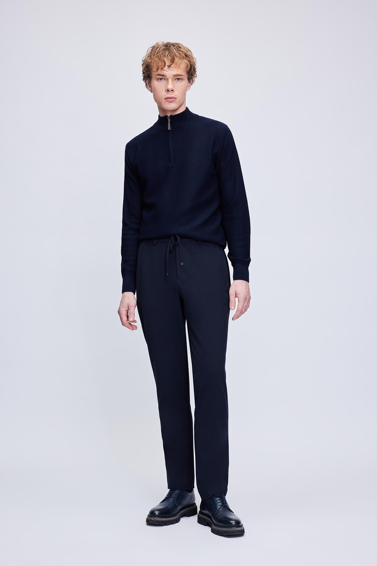 Black wool-blend turtleneck sweater with a half-zip front and ribbed cuffs.