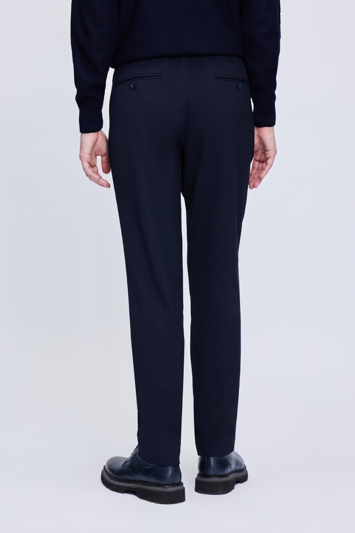 Dark navy wool trousers with a sleek, tailored fit and subtle front pockets.