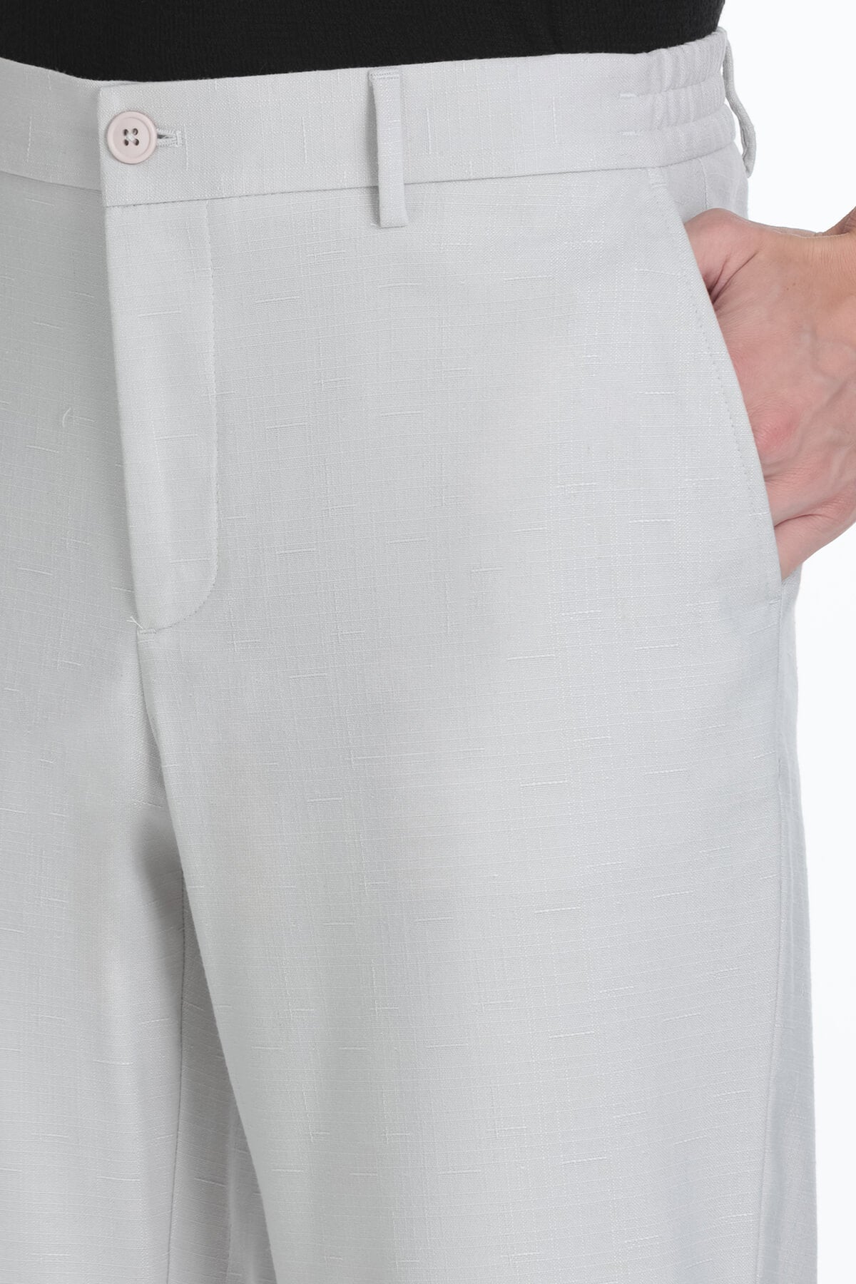 Light gray textured dynamic fit stone linen blend jogger pants with subtle pattern and matching button closure