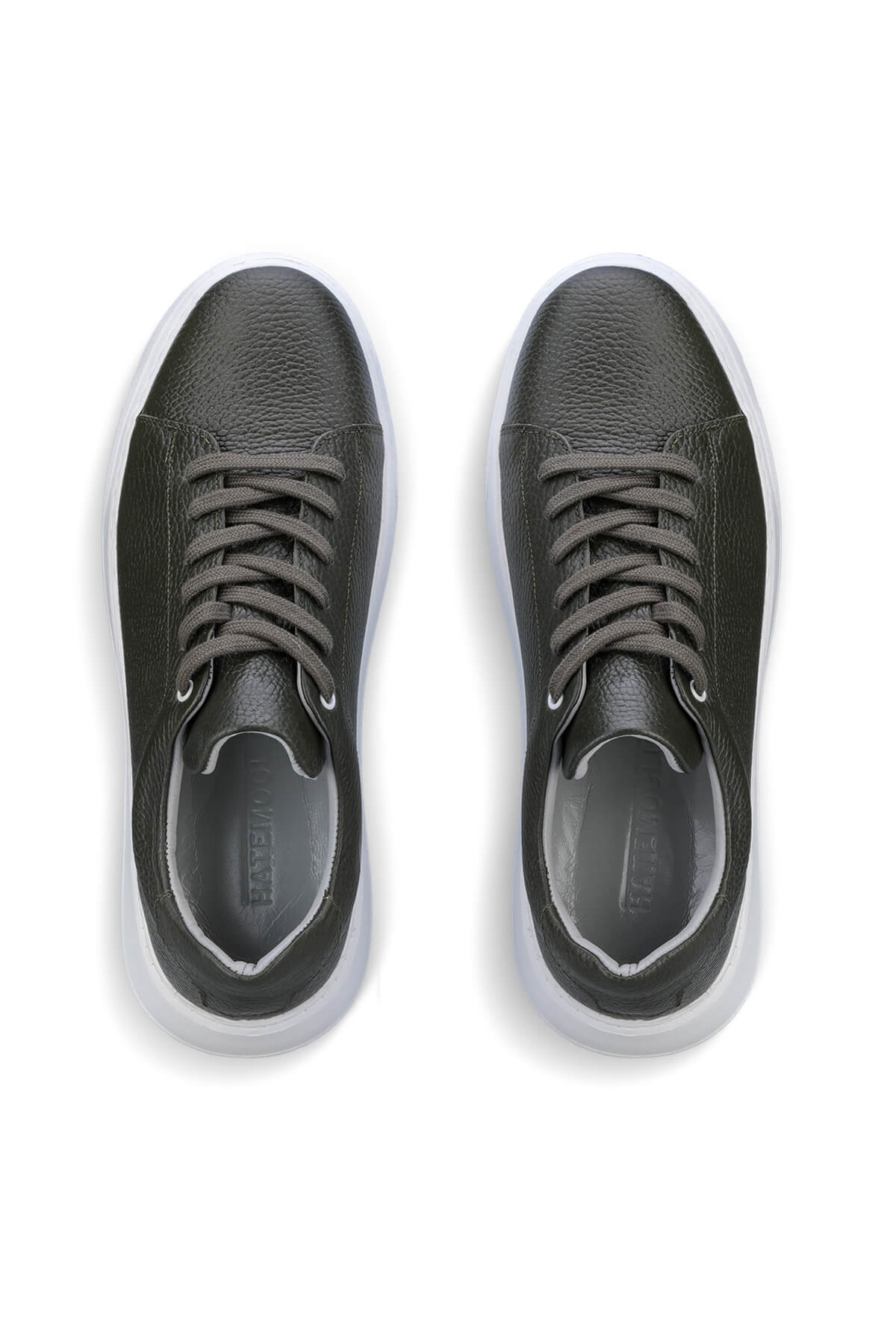 Black leather sneakers with white soles and gray laces.