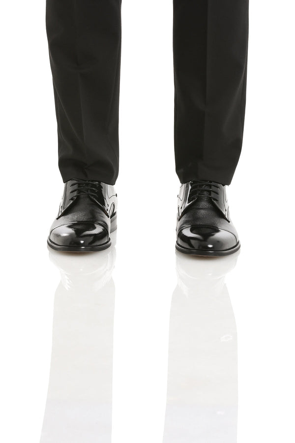 Black patent leather dress shoes with a glossy finish and classic lace-up design.