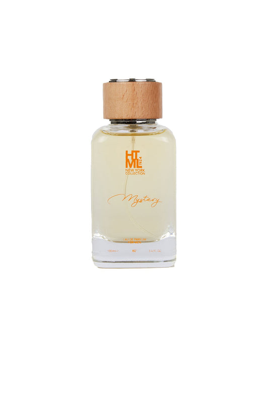 A clear glass bottle of htm new york collection ’mystery’ perfume with a light amber liquid, topped by a natural wood cap.