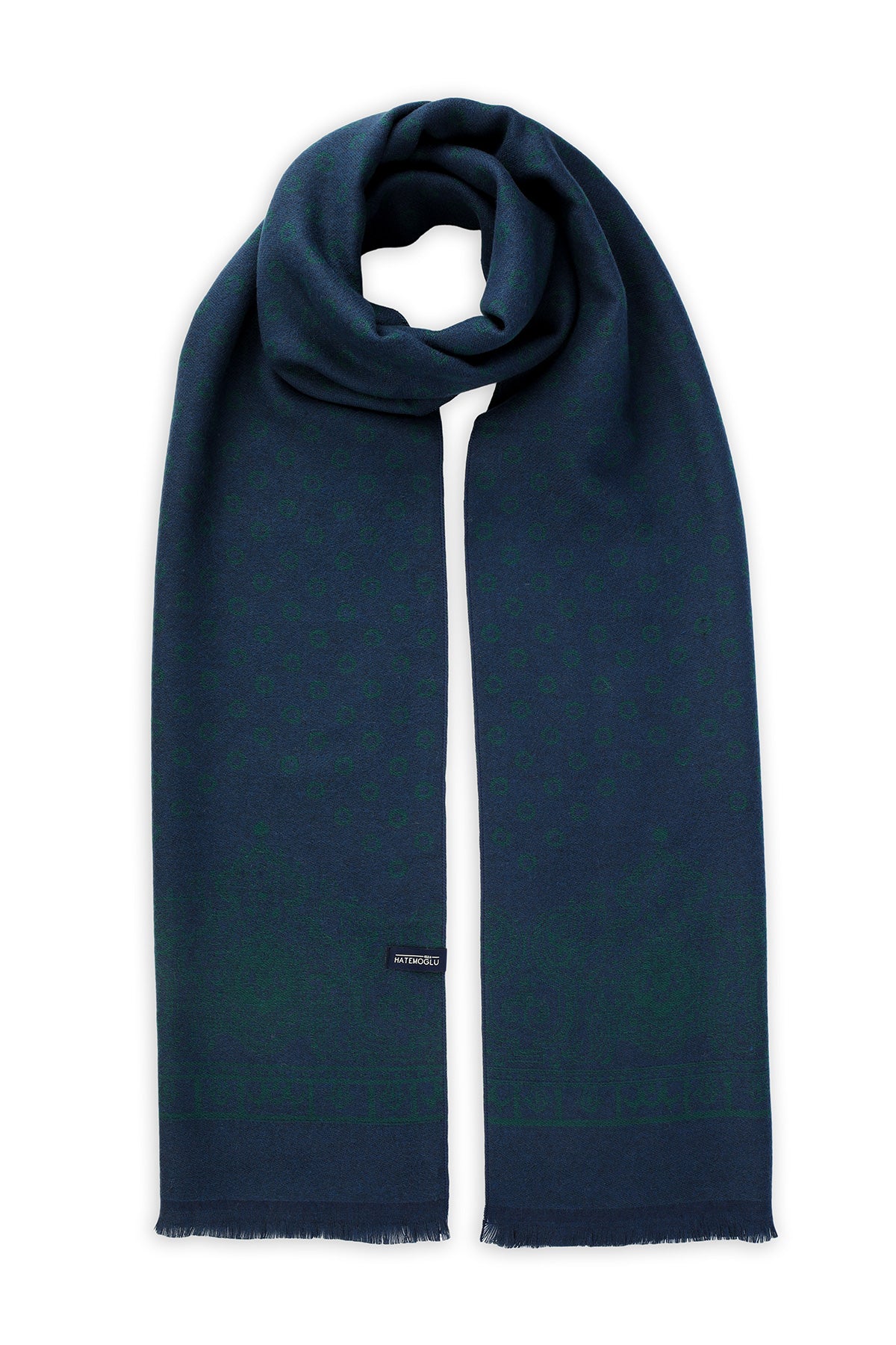 A navy blue scarf with a subtle gradient to deep green at the ends, featuring frayed edges and a small black brand tag.
