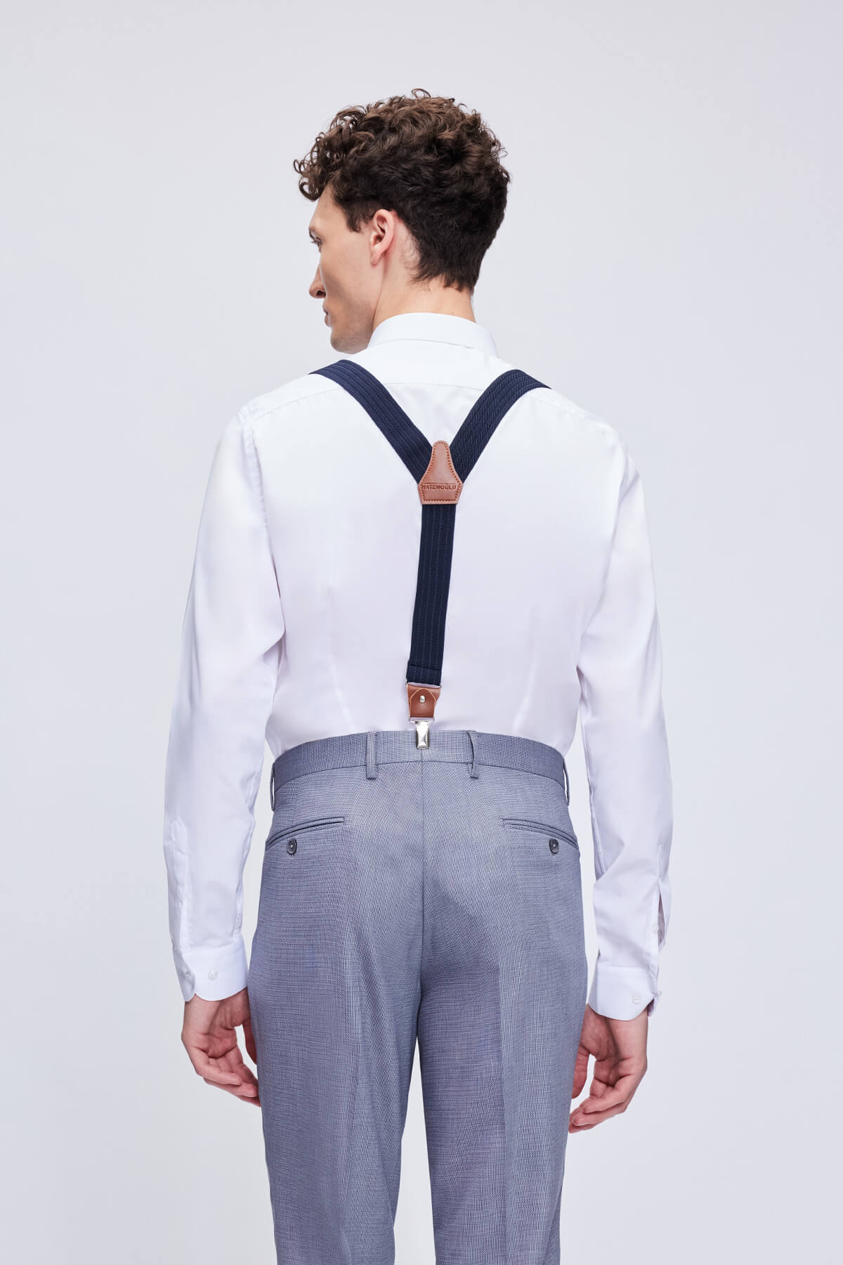 Navy blue clip suspenders with brown leather trim and clasps for a stylish and durable accessory