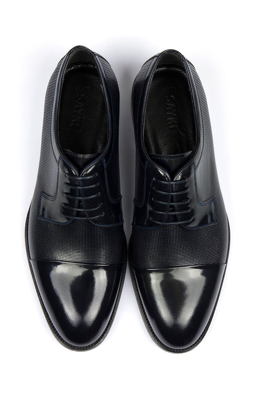 Black men’s dress shoes with a glossy toe cap and textured leather panels.
