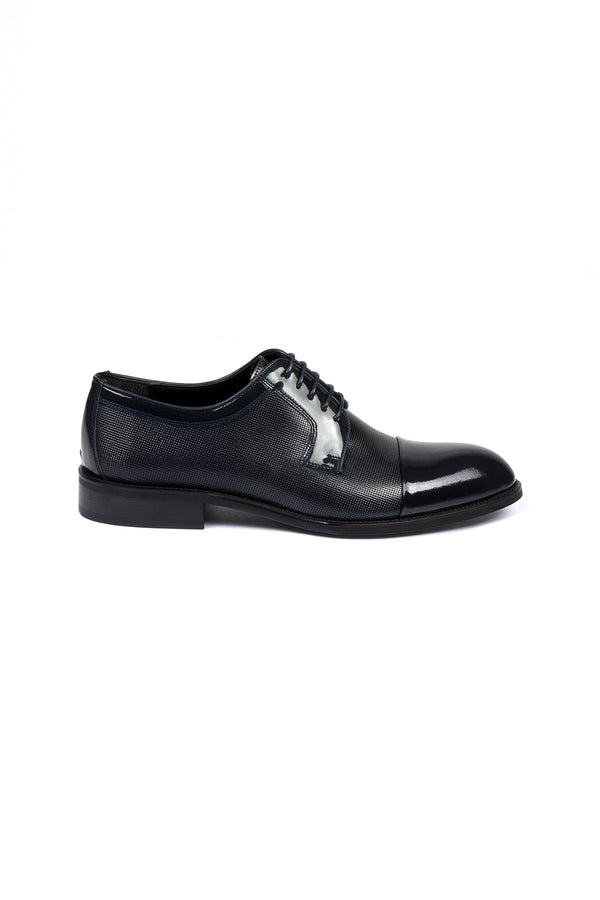 Black men’s dress shoe with a glossy toe cap and textured leather upper.