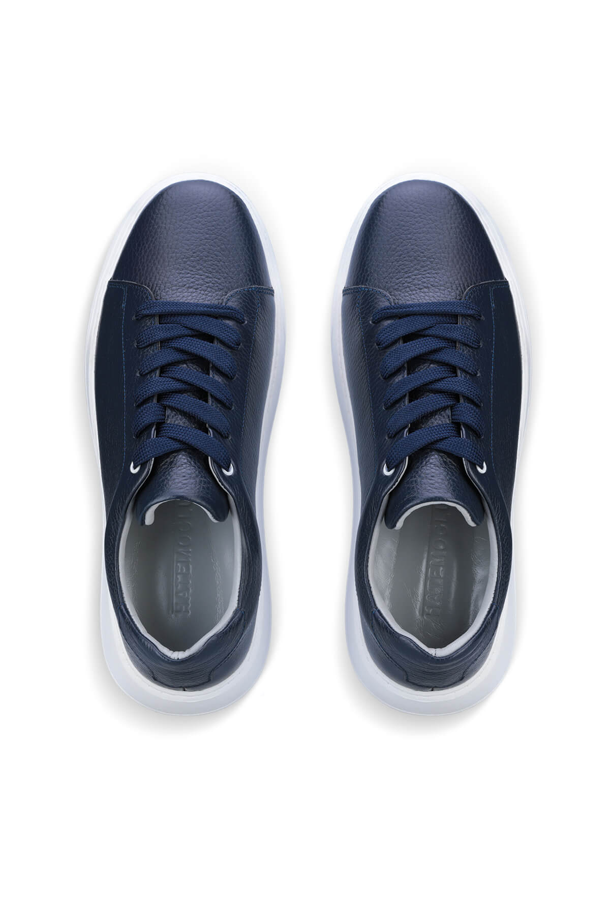 Navy blue leather sneakers with white soles and matching laces