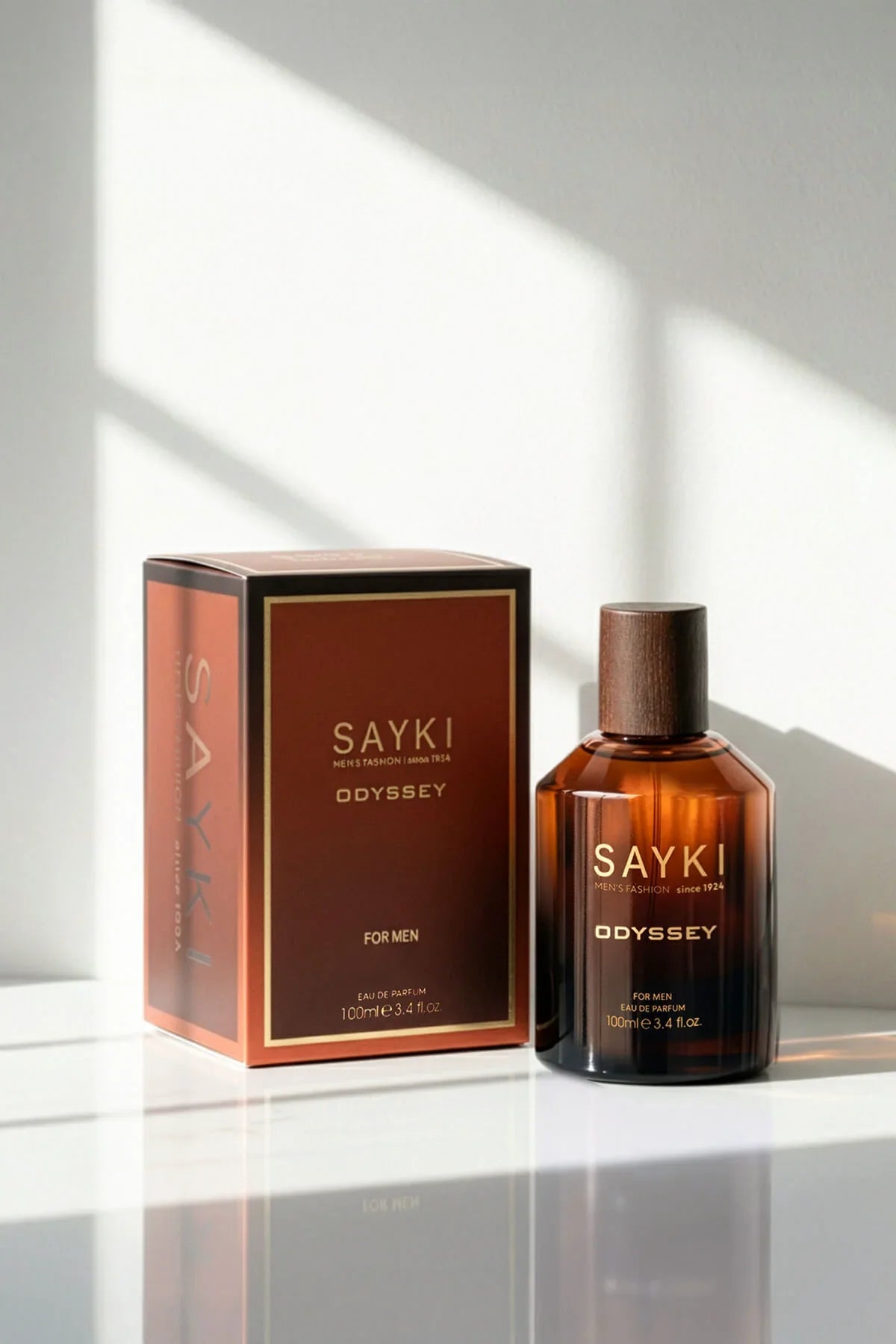 Sayki odyssey men’s eau in a sleek amber glass bottle with dark wood cap and matching brown box 100 ml