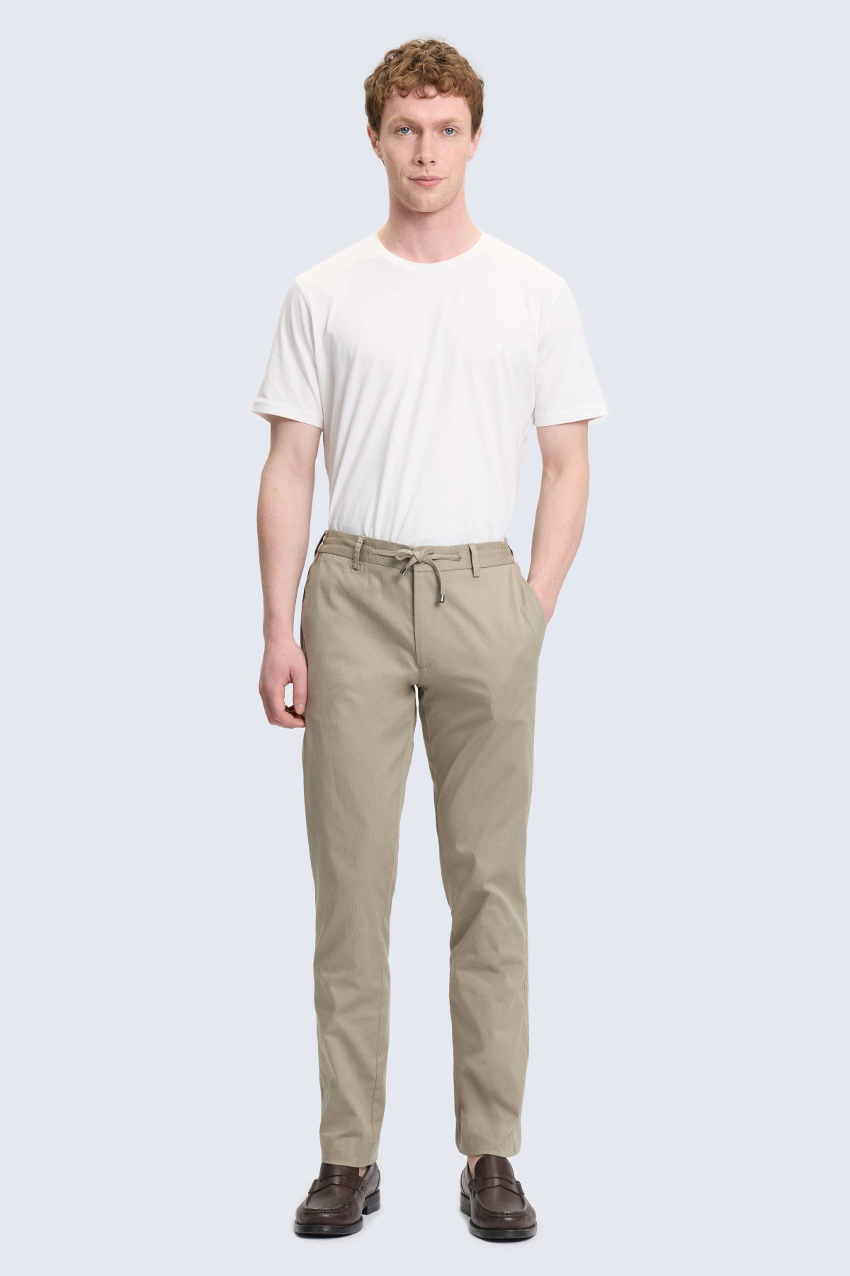 Beige cotton chino trousers with drawstring waistband complement olive dynamic fit jogger pants style