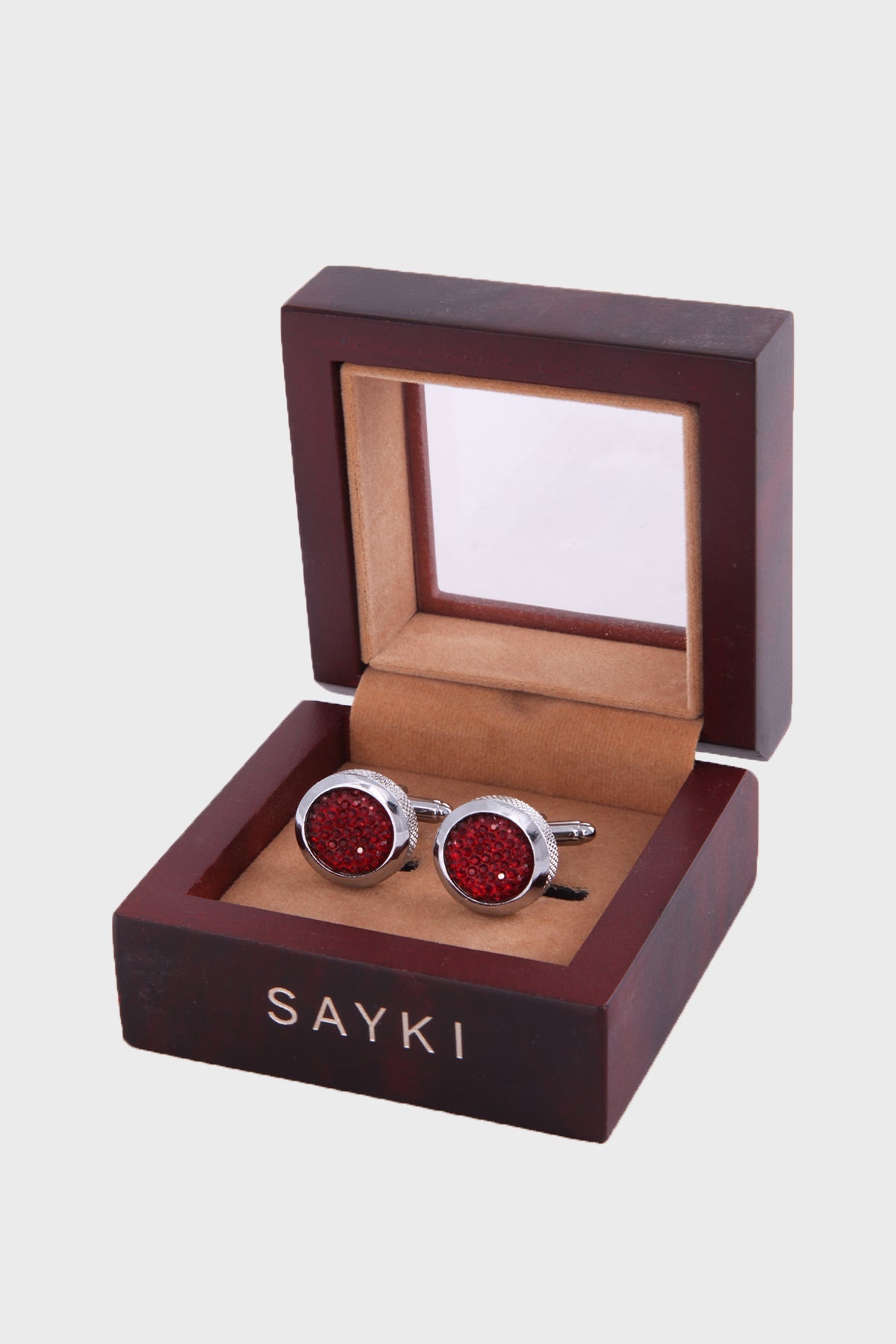 Red glittery circular cufflinks with silver-toned metal frames, presented in a dark wood box.