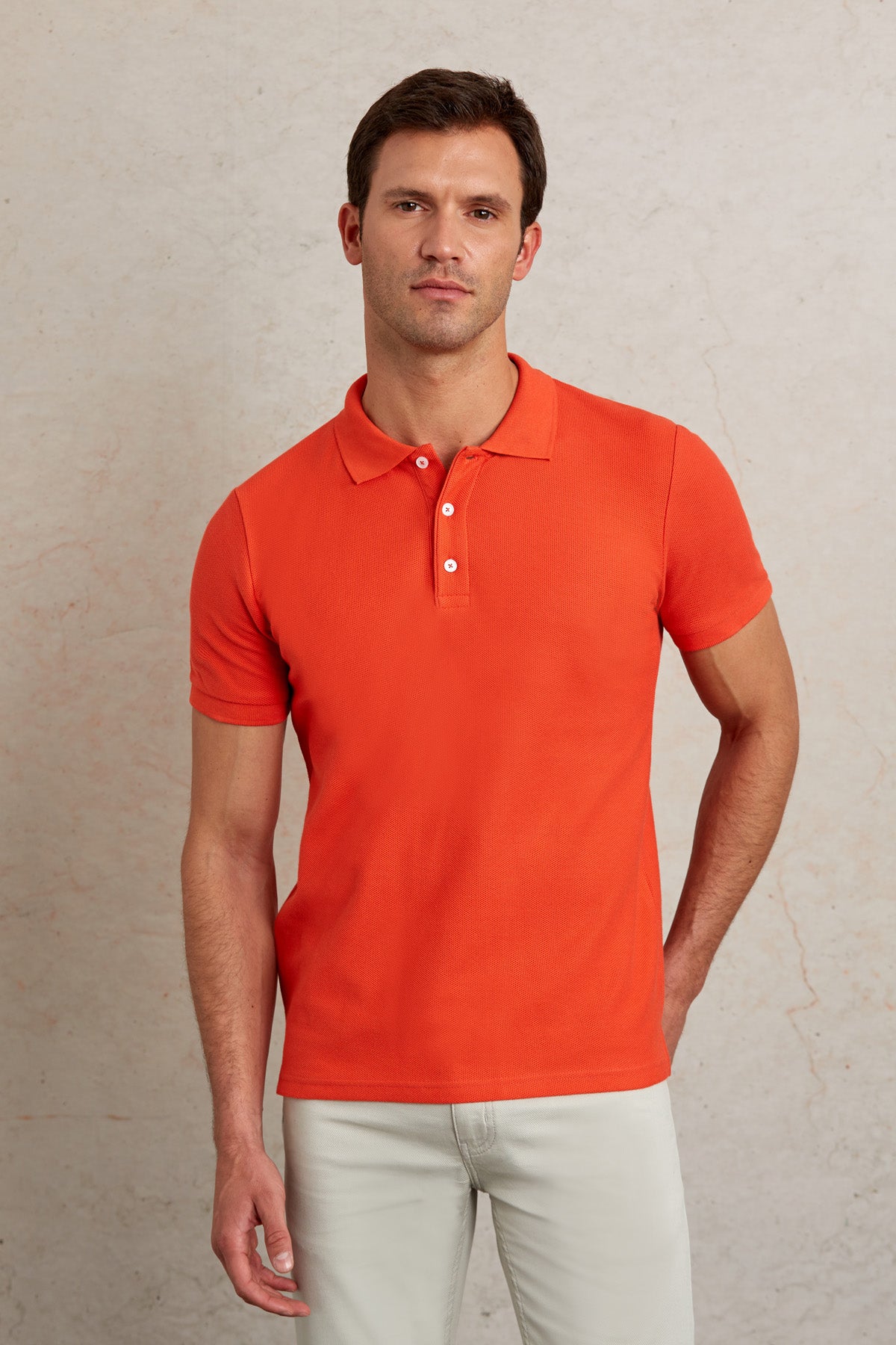 Bright orange short-sleeved polo shirt with a classic collar and white buttons.